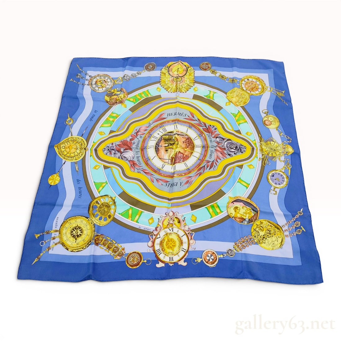 Herm?¨s La Ronde des Heures Silk Scarf by Loic Dubigeon: This Hermès silk twill scarf features the La Ronde des Heures pattern, designed by artist Loic Dubigeon. The central motif depicts a scenic sunburst clock face surrounded by concentric rings in