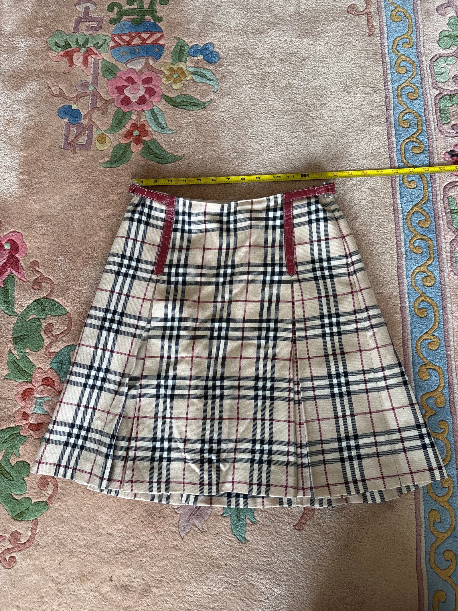 Burberry London Blue Label Nova Check Wool Pleated Mini Skirt: This pleated mini skirt is from the Burberry London Blue Label collection, a line produced under license for the Japanese market. The garment features the signature Nova Check pattern in beige, black,
