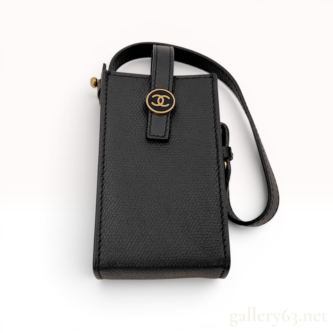 Chanel Black Caviar Leather Coco Button Cigarette Case with Wristlet: This Chanel cigarette case is crafted from black caviar leather, characterized by its pebbled grain. The vertical rectangular pouch features a front flap secured by a gold-tone snap button with a blac