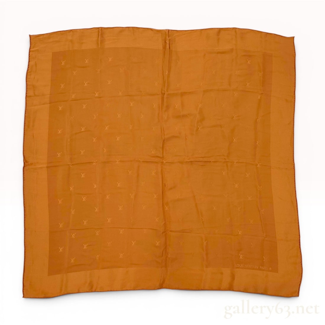 Louis Vuitton Carre Monaco Monogram Silk Scarf: Louis Vuitton square silk scarf in an ochre colorway featuring a jacquard woven LV monogram pattern. The scarf is constructed from 100% silk with hand-rolled edges and a slightly darker solid border. 