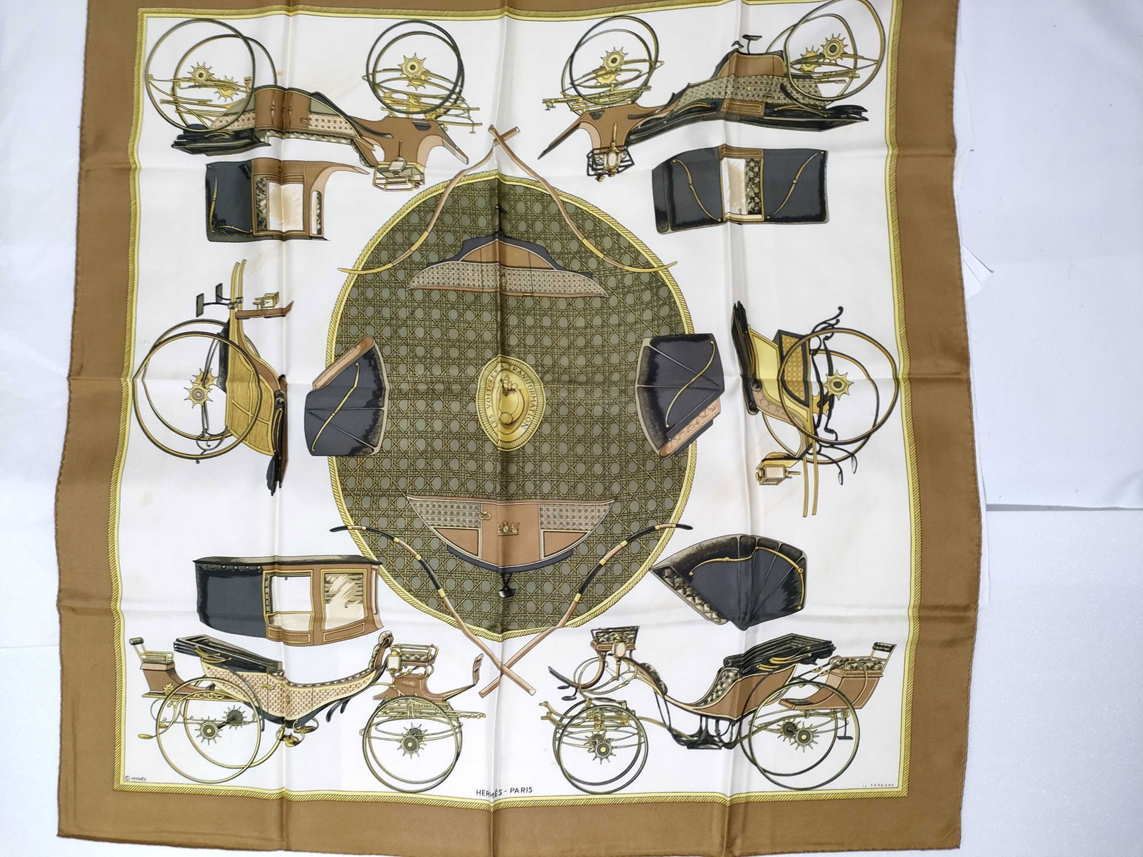 Hermes Les Voitures a Transformation Silk Scarf by Francoise de La Perriere: An authentic Hermes silk twill square scarf featuring the Les Voitures a Transformation pattern, originally designed by Francoise de La Perriere in 1965. The design illustrates various convertible hor