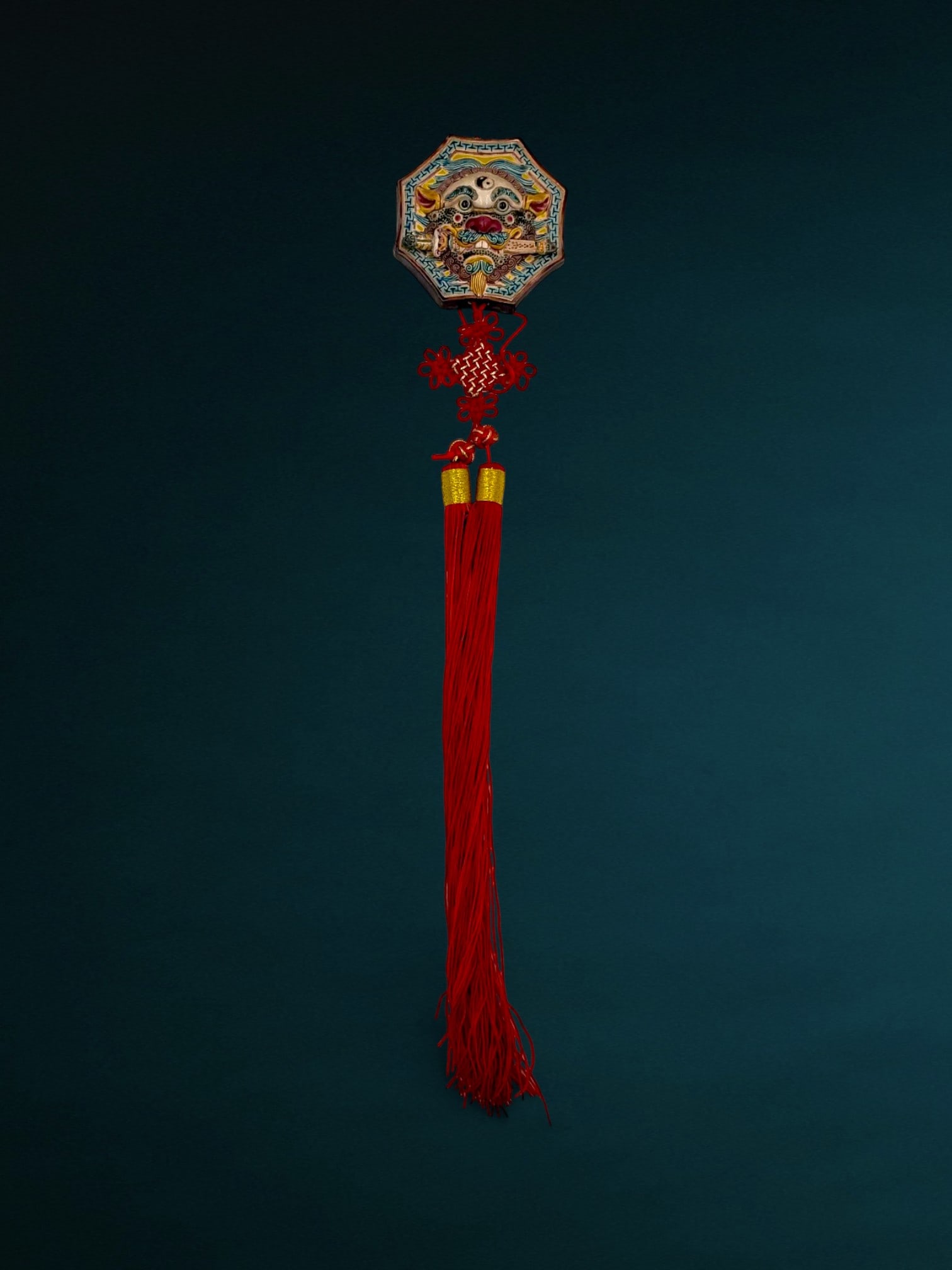 Chinese Polychrome Glazed Ceramic Bagua Wall Hanging with Tassel: Contemporary Chinese decorative wall hanging featuring an octagonal ceramic plaque with a sword-biting lion motif. The molded relief plaque is decorated in polychrome glazes with a Yin-Yang symbol and