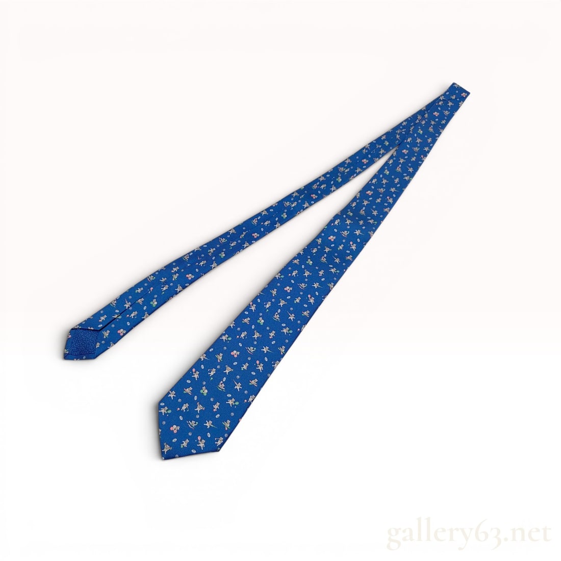 Bulgari Seven-Fold Silk Novelty Sport Cat Print Necktie: A premium handmade seven-fold silk necktie by Bulgari. The tie is constructed from 100 percent royal blue silk featuring a novelty print of white cats in sporting poses, including rowing in pink scull