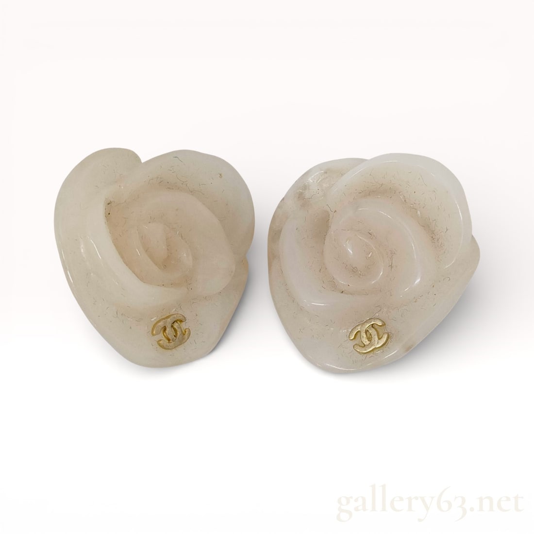Chanel Camellia Plastic Clip-On Earrings: Authentic Chanel camellia motif earrings formed in molded translucent plastic, presenting sculptural floral shapes with softly rounded petals. Each earring set with a small gold-tone interlocking CC e