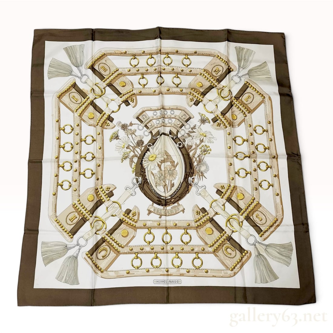 Hermes Aux Champs Silk Scarf: Vintage Hermes silk twill scarf in the Aux Champs pattern, designed by Cathy Latham and first issued in 1970. The design features a central equestrian horse collar framing a delicate bouquet of wildfl