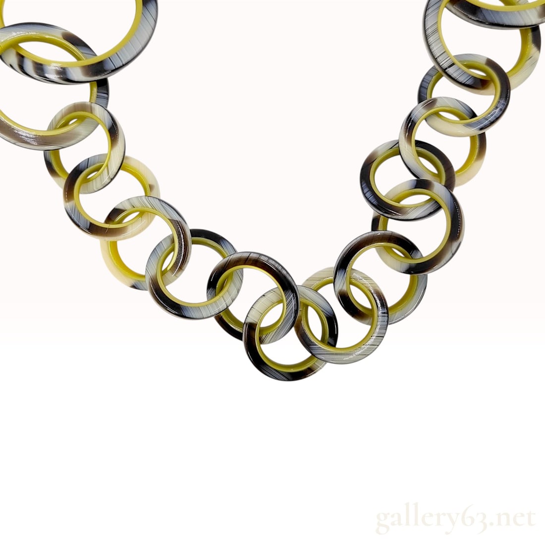 Hermes Graduated Water Buffalo Horn Interlocking Ring Necklace with Sterling Silver Clasp: This graduated interlocking ring link necklace is identified as Hermes, crafted from natural water buffalo horn. The links feature a variegated color palette of black, cream, and olive green. The neck