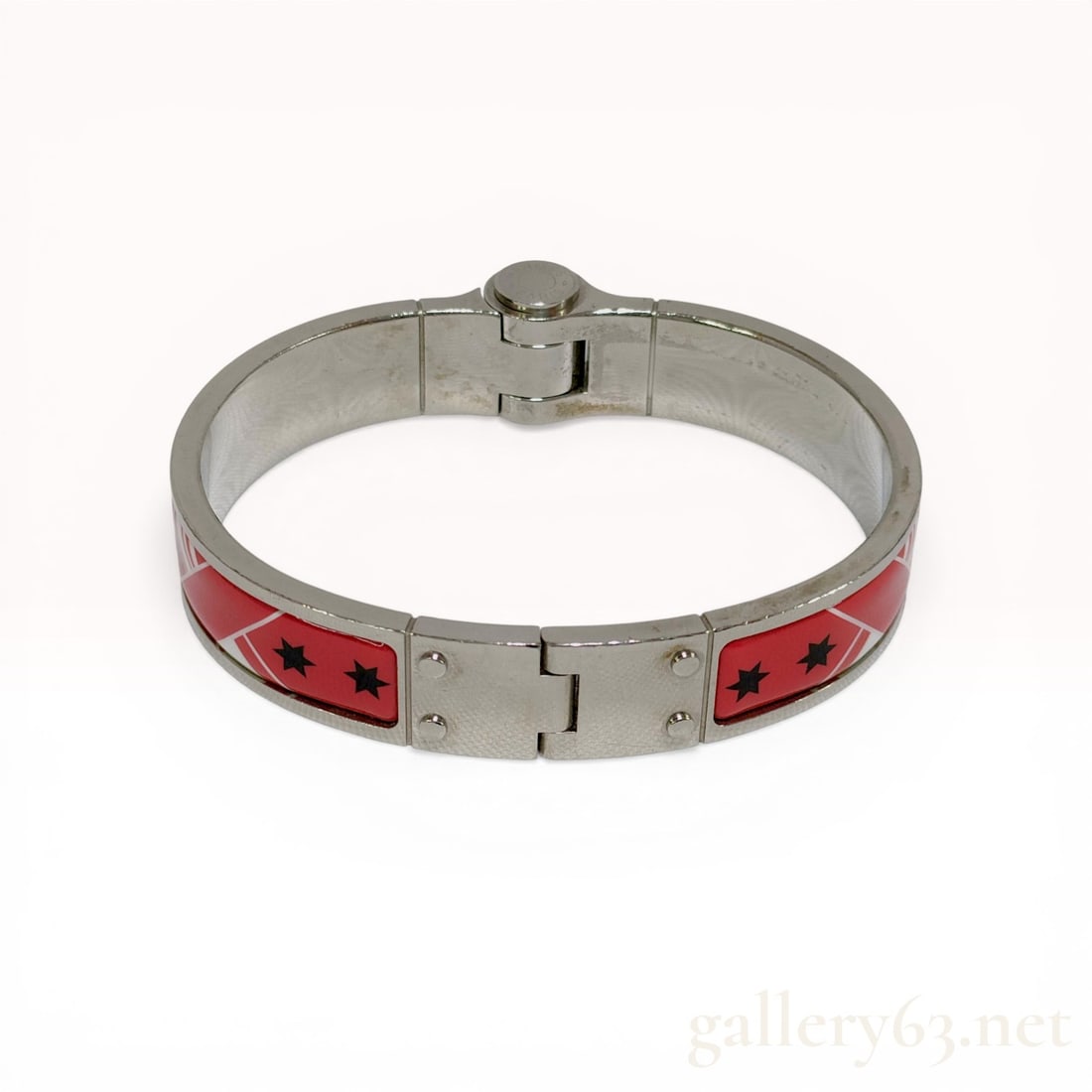 Hermes Enamel and Silver-Tone Charniere Hinged Bangle Bracelet: Hermes Charniere hinged bangle bracelet featuring polished silver-tone metal construction. The exterior is decorated with inset red enamel panels depicting black stars and a red-and-white striped grap