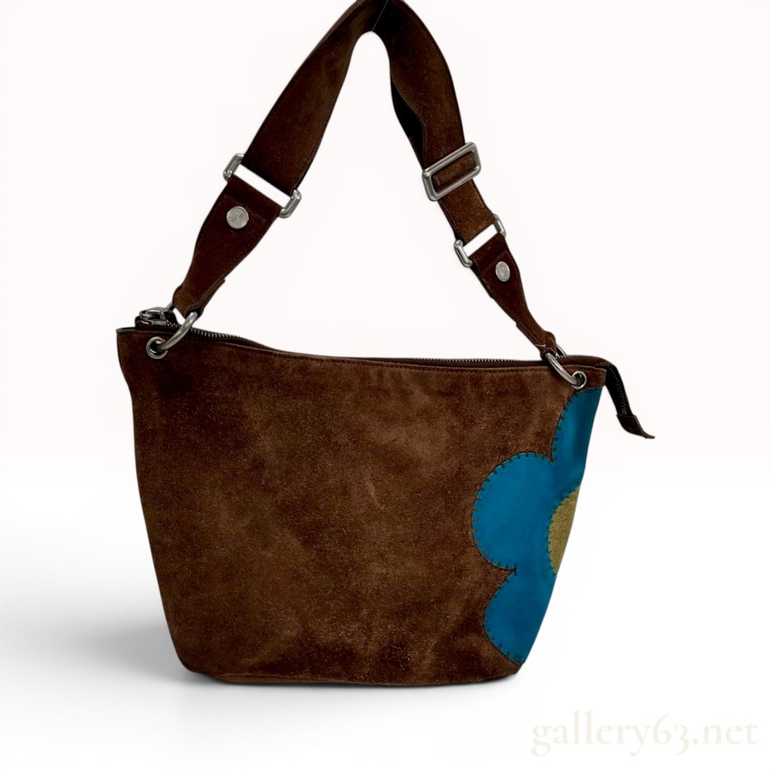 Celine Suede Flower Applique Shoulder Bag: This Celine hobo-style shoulder bag is crafted from dark brown suede. The exterior features a prominent blue and yellow suede flower applique on the front corner, secured with decorative stitching. Th