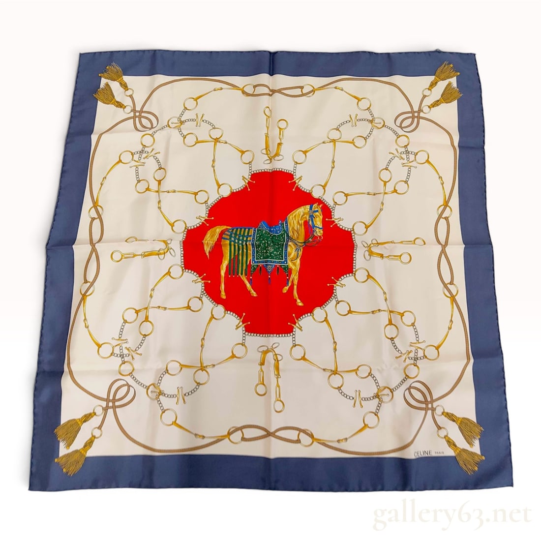 Celine Paris Vintage Silk Scarf with Equestrian Horse Motif: A vintage silk scarf by Celine Paris featuring an equestrian motif. The central design depicts a caparisoned horse standing on a vibrant red circular ground. This central medallion is framed by a comp