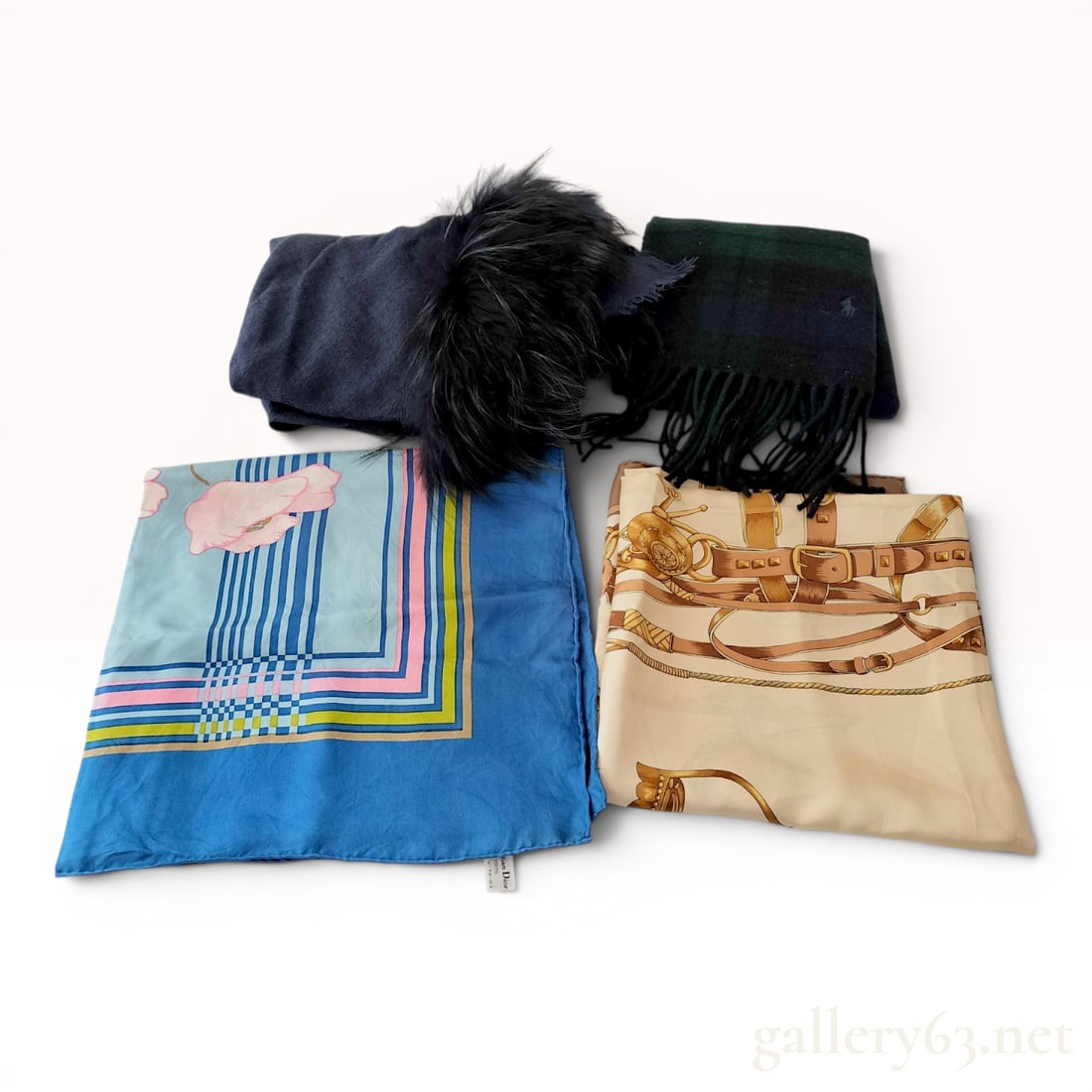 A Group of Four Designer Silk and Wool Scarves and Wraps: A collection of four designer scarves and wraps including pieces from Christian Dior, Celine, and Polo Ralph Lauren. The lot features a Christian Dior blue silk poppy scarf with a geometric border, a 