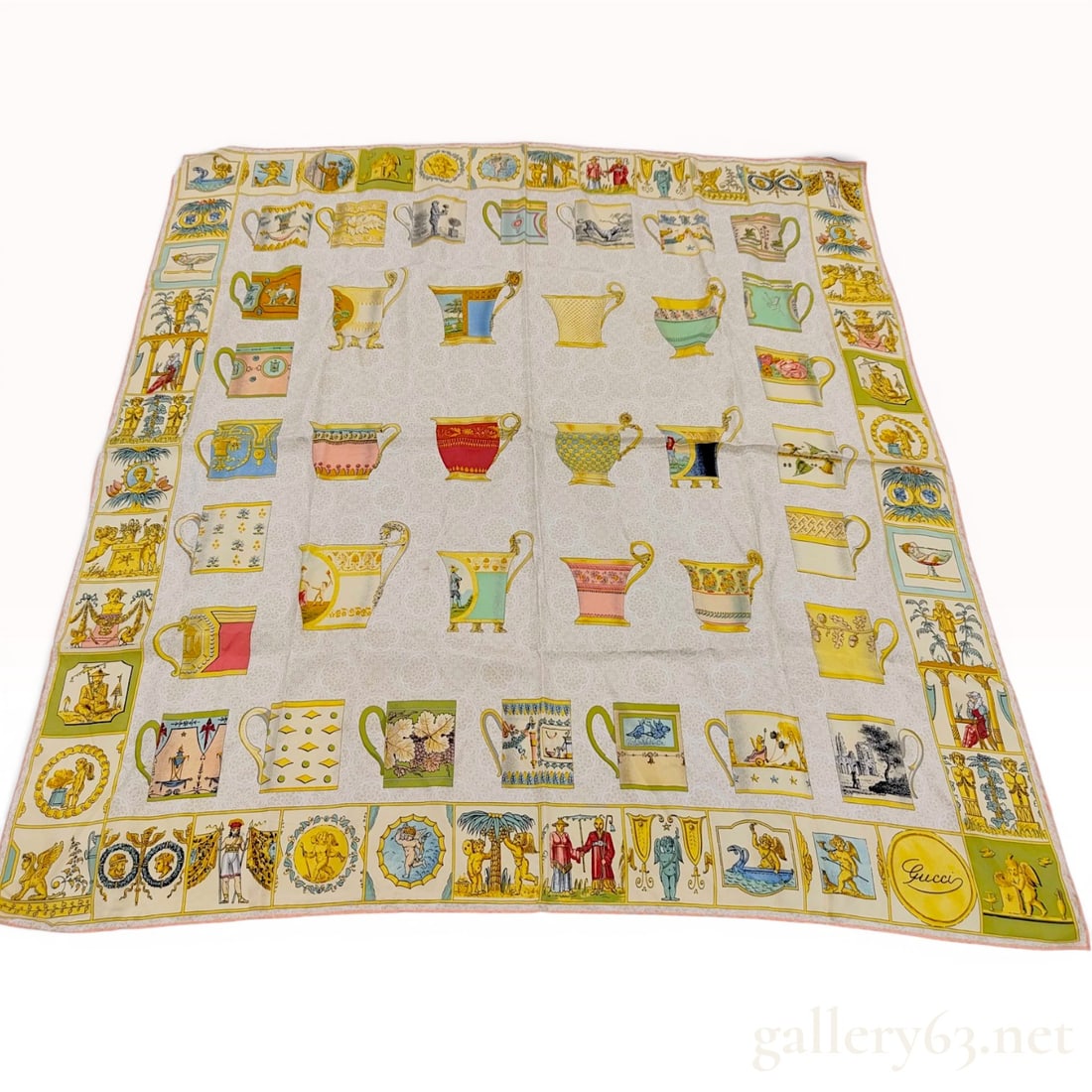Gucci Vintage Silk Teacup and Mug Pattern Scarf: This vintage square silk scarf by Gucci features a central cream field decorated with a subtle tone-on-tone damask floral pattern. The primary design consists of twenty-four uniquely illustrated teacu
