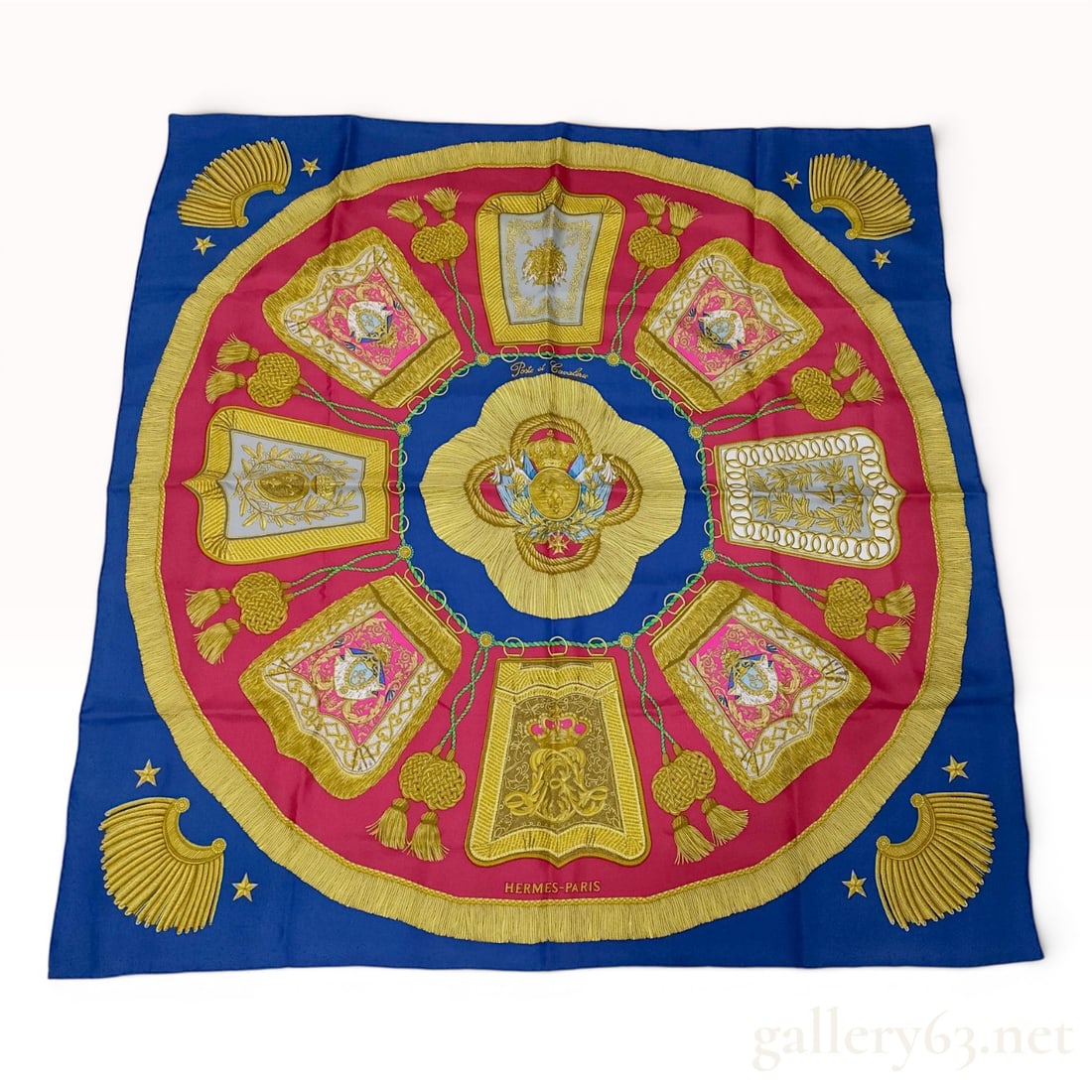 Hermes Poste et Cavalerie Silk Scarf: This square silk twill scarf is a Hermes carrÄ— featuring the Poste et Cavalerie pattern designed by Philippe Ledoux. The central design depicts a heraldic shield with three fleurs-de-lis, topped w