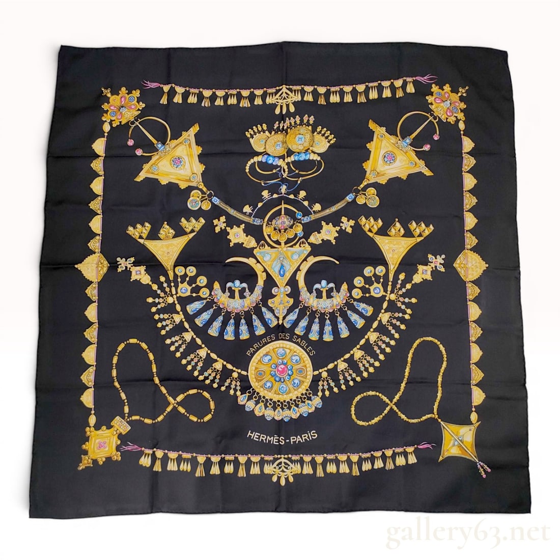Hermes Silk Carre 90 Scarf Parures des Sables: A 100 percent silk square scarf by Hermes featuring the Parures des Sables pattern designed by Laurence Bourthoumieux. The design consists of a black ground decorated with elaborate North African and 