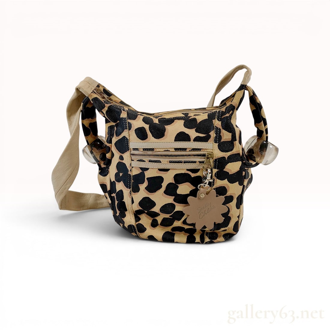 See by Chloe Leopard Print Leather Hobo Bag: See by Chloe hobo-style shoulder bag featuring a bold leopard-print pebbled leather body and tan leather trim. The exterior is detailed with a single wide shoulder strap, two clear acrylic ball charms