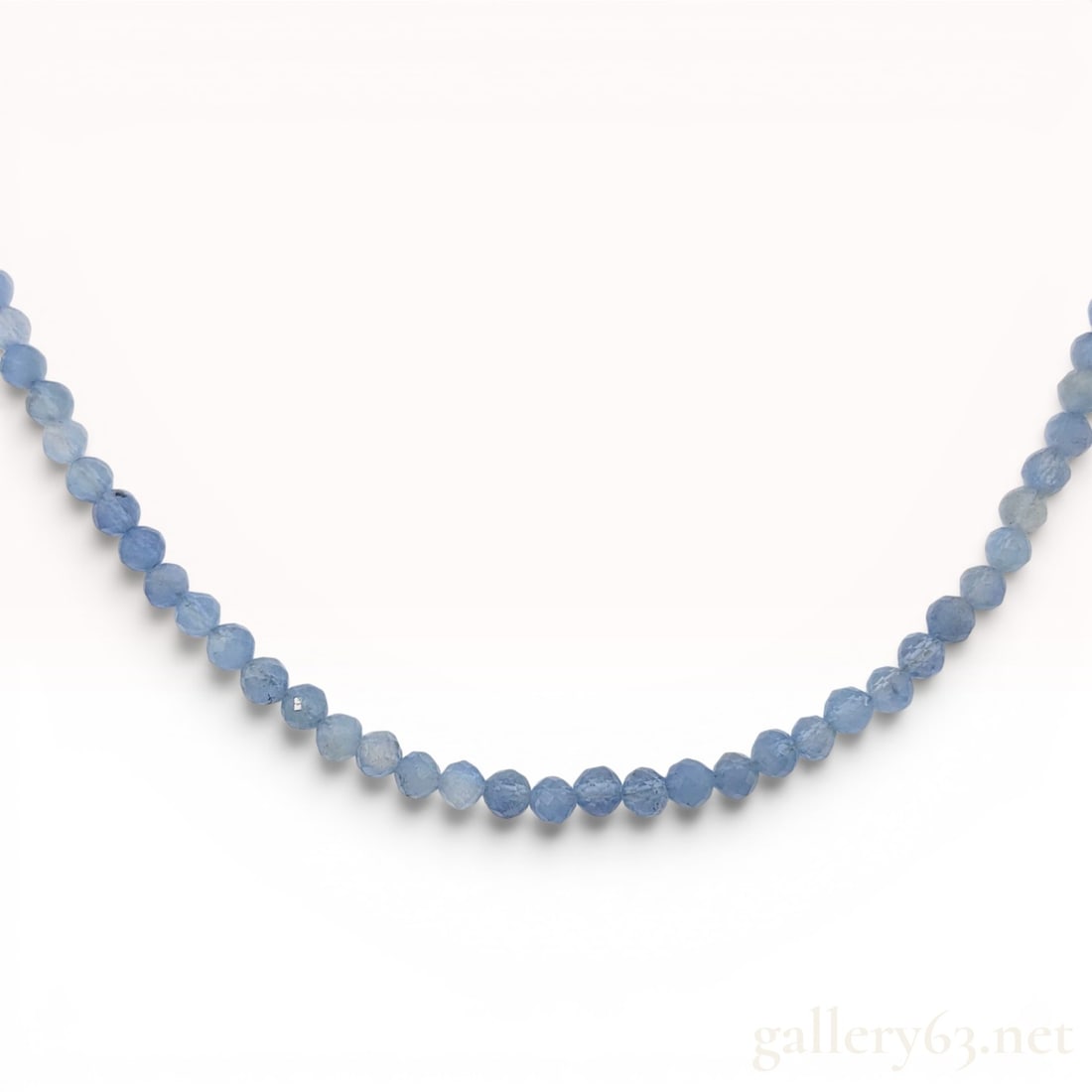 Faceted Natural Aquamarine Bead Necklace with Sterling Silver Toggle Clasp: A single-strand gemstone necklace composed of faceted rondelle-cut beads. The beads are identified as natural aquamarine, a variety of the mineral beryl, characterized by a translucent light blue colo