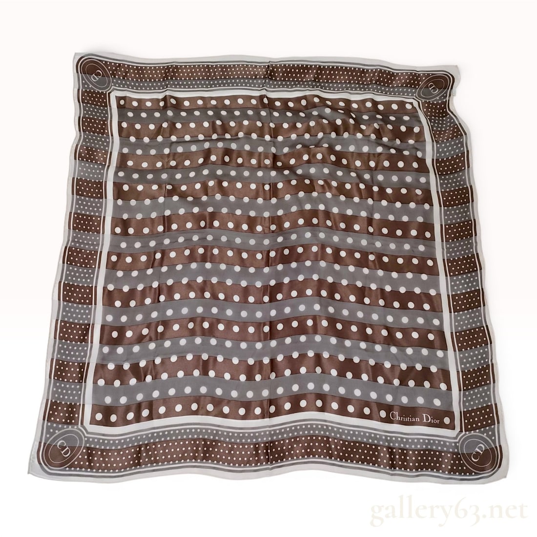 Christian Dior Silk Polka Dot Square Scarf: A square silk scarf produced by Christian Dior. The textile features a pattern of horizontal stripes in alternating shades of brown and charcoal gray, overlaid with white polka dots. A wide dark brown