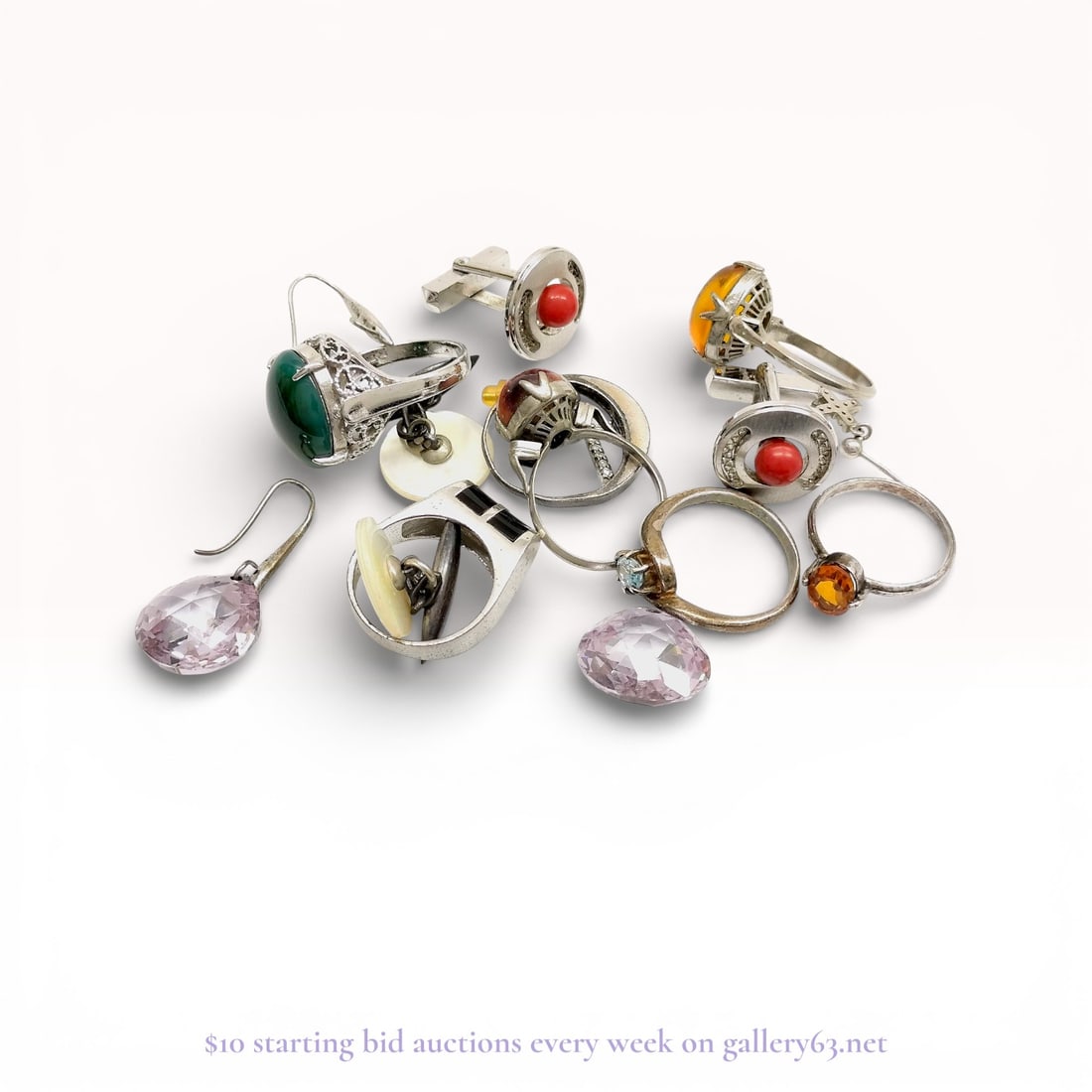 An Assortment of Sterling Silver Jewelry and Accessories: An assortment of sterling silver jewelry and gentleman's accessories including rings, cufflinks, and earrings. Featured items include a filigree ring with a green cabochon, a reddish-brown cabochon ri