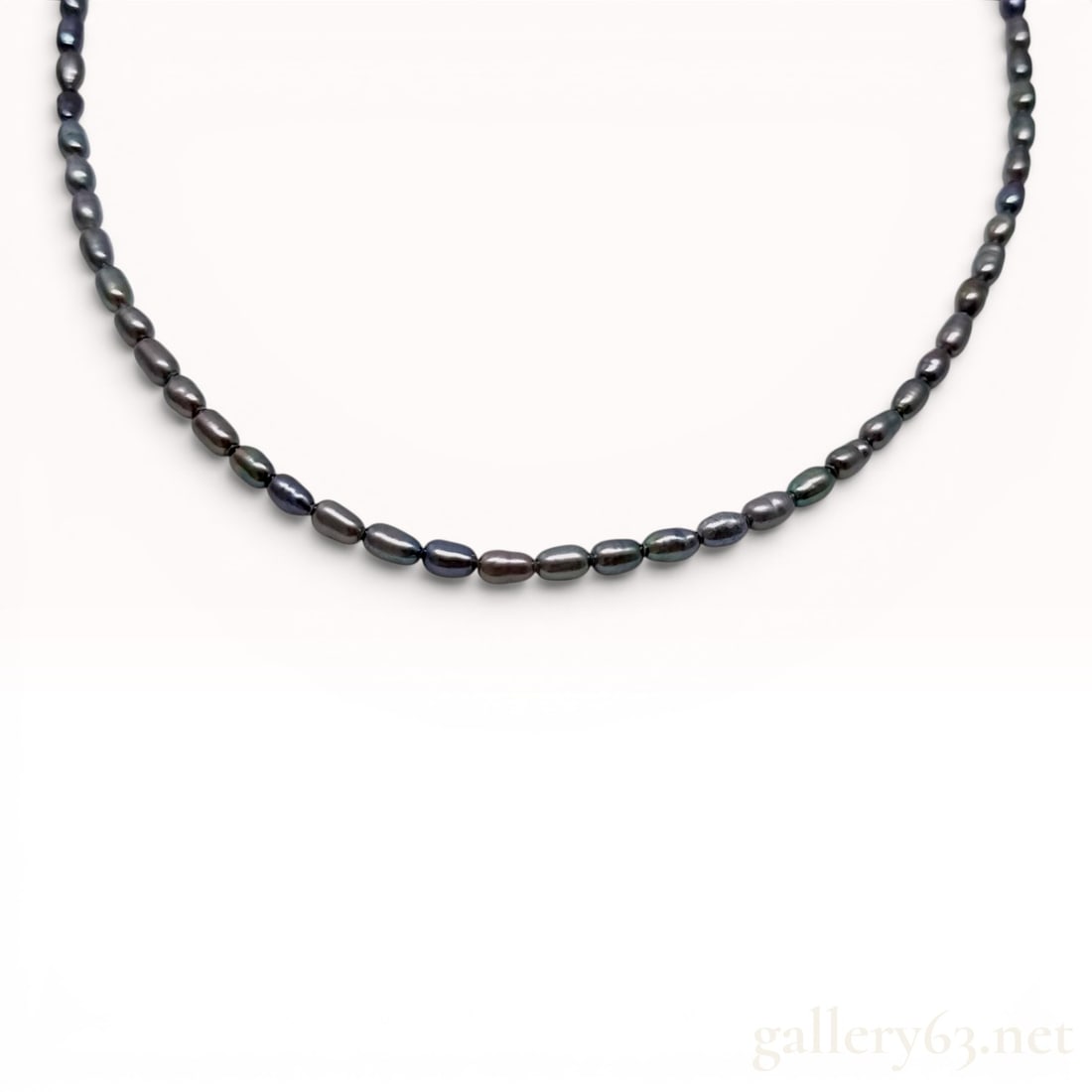 Rice-Shaped Black Cultured Freshwater Pearl and 18K White Gold Necklace: This is a single-strand necklace featuring numerous rice-shaped cultured freshwater pearls. The pearls possess a dark gray to black body color characterized by iridescent peacock overtones in shades o