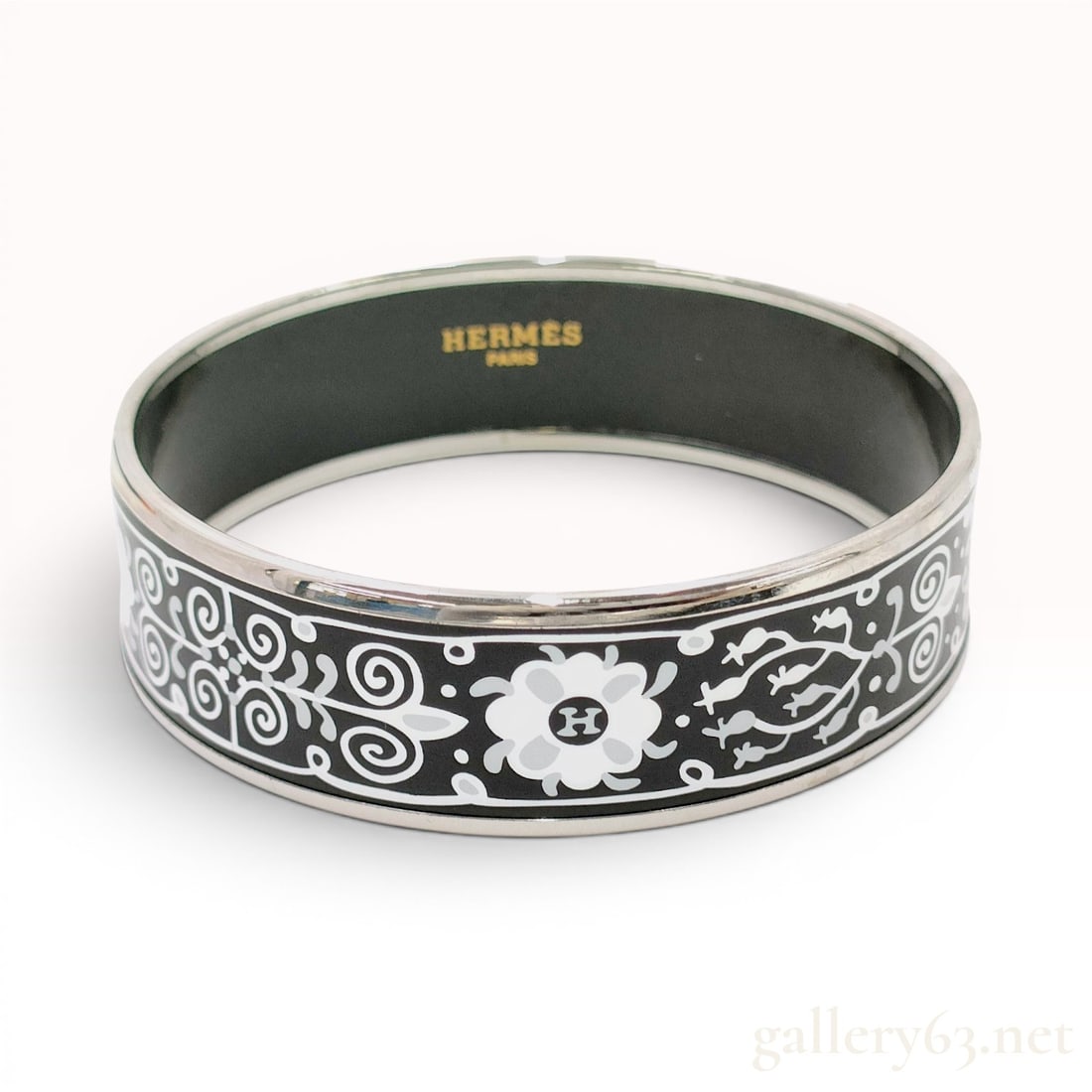 Hermes Wide Printed Enamel Balcons du Guadalquivir Bangle Bracelet with Box: This Hermes wide printed enamel bangle bracelet features the Balcons du Guadalquivir pattern, consisting of stylized white and gray floral and scrollwork motifs against a black ground. The design inco