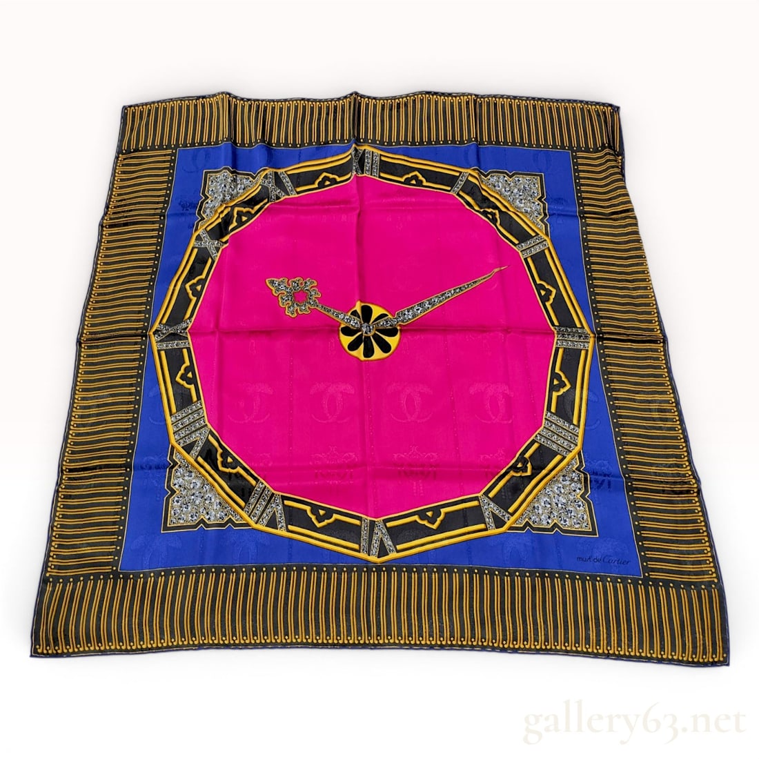 Must de Cartier Vintage Silk Scarf with Clock Hand Motif: This square silk scarf is from the must de Cartier collection by Cartier. The piece is constructed from 100 percent silk and features hand-rolled edges. The design centers on a fuchsia pink octagonal 