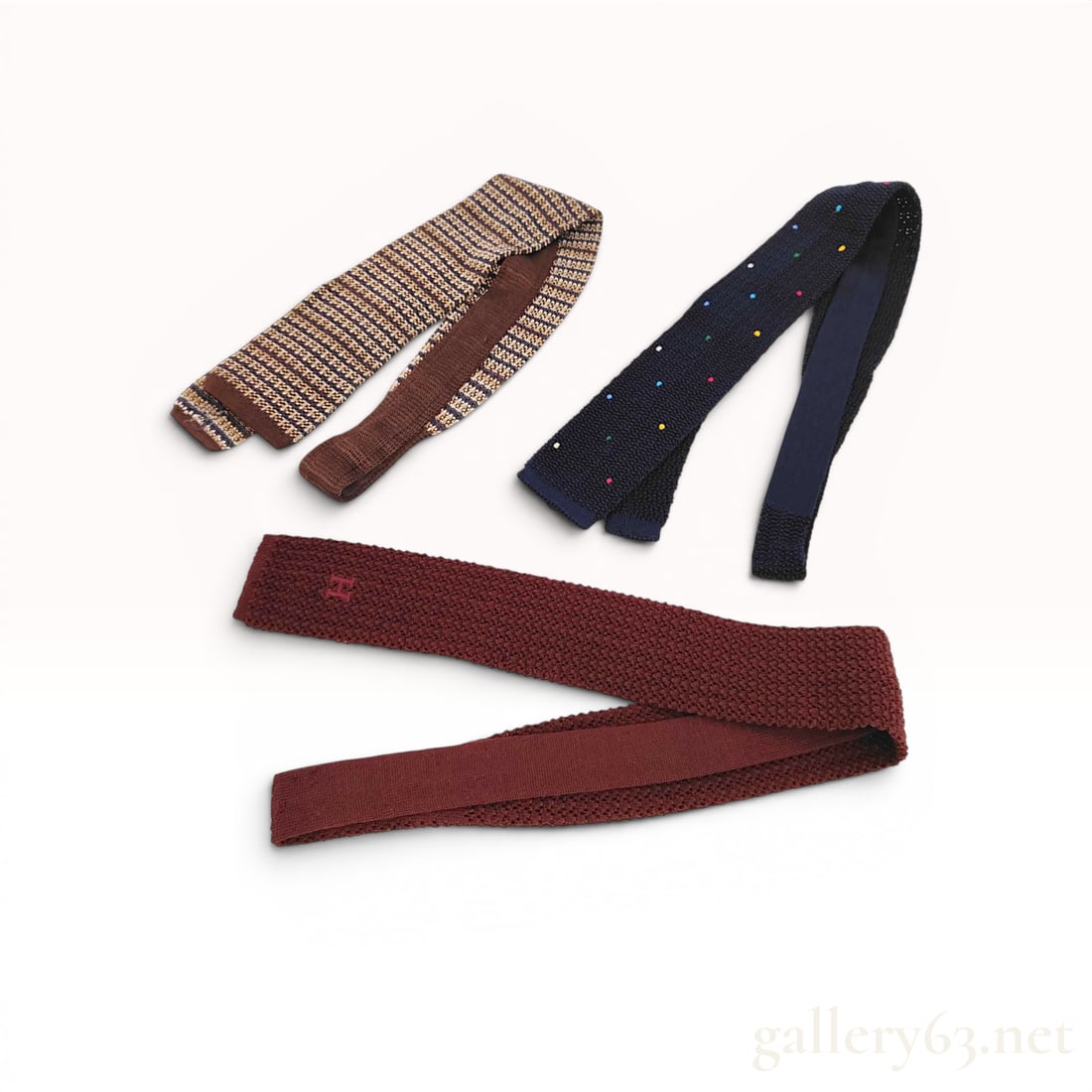 Three Hermes Silk Knit Neckties and Box: This set of three designer neckties from Hermes is crafted from 100% silk knit. The collection includes one navy blue tie featuring raised, multicolored embroidered dots in shades of yellow, green, pi
