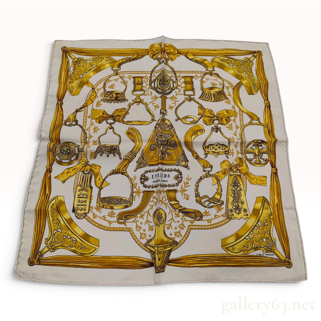 Hermes Etriers Silk Gavroche Scarf: Hermes silk gavroche scarf, also referred to as a pocket square, featuring the Etriers pattern originally designed by artist Francoise de la Perriere in 1964. The square silk textile displays a centra