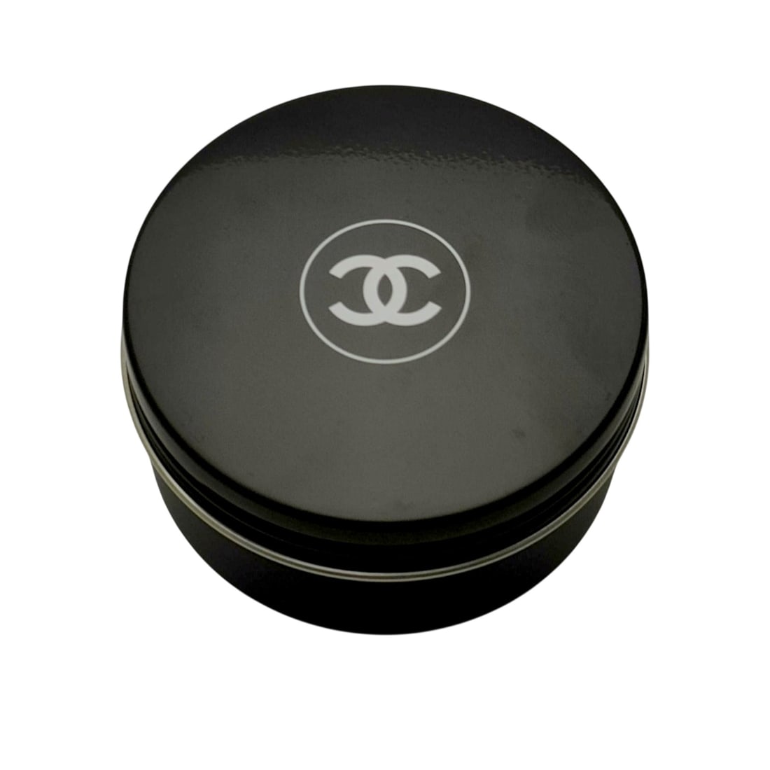 Chanel Bleu de Chanel All-Over Balm in Original Packaging: Chanel Bleu de Chanel All-Over Balm (Baume Tout Usage), contemporary. The grooming product is contained within a navy blue circular metal tin with a matte lid featuring the white interlocking CC logo 