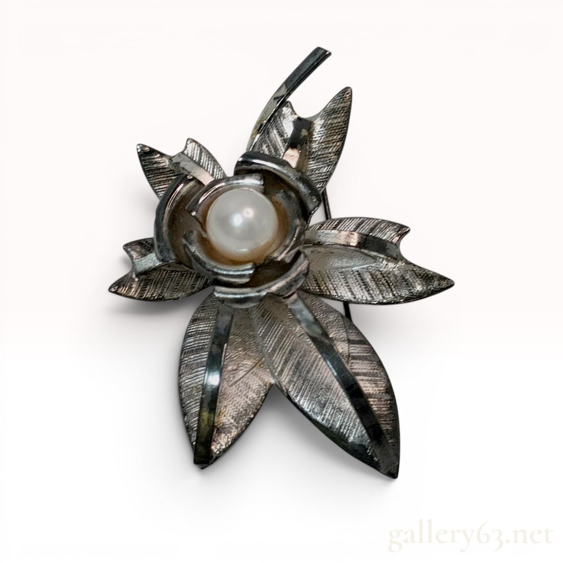 Vintage Silver Floral Spray Brooch with Central Pearl: Vintage mid-century style floral spray brooch featuring a stylized rose blossom with a central pearl and four textured leaves. The piece is constructed of silver with a brushed, cross-hatched finish o