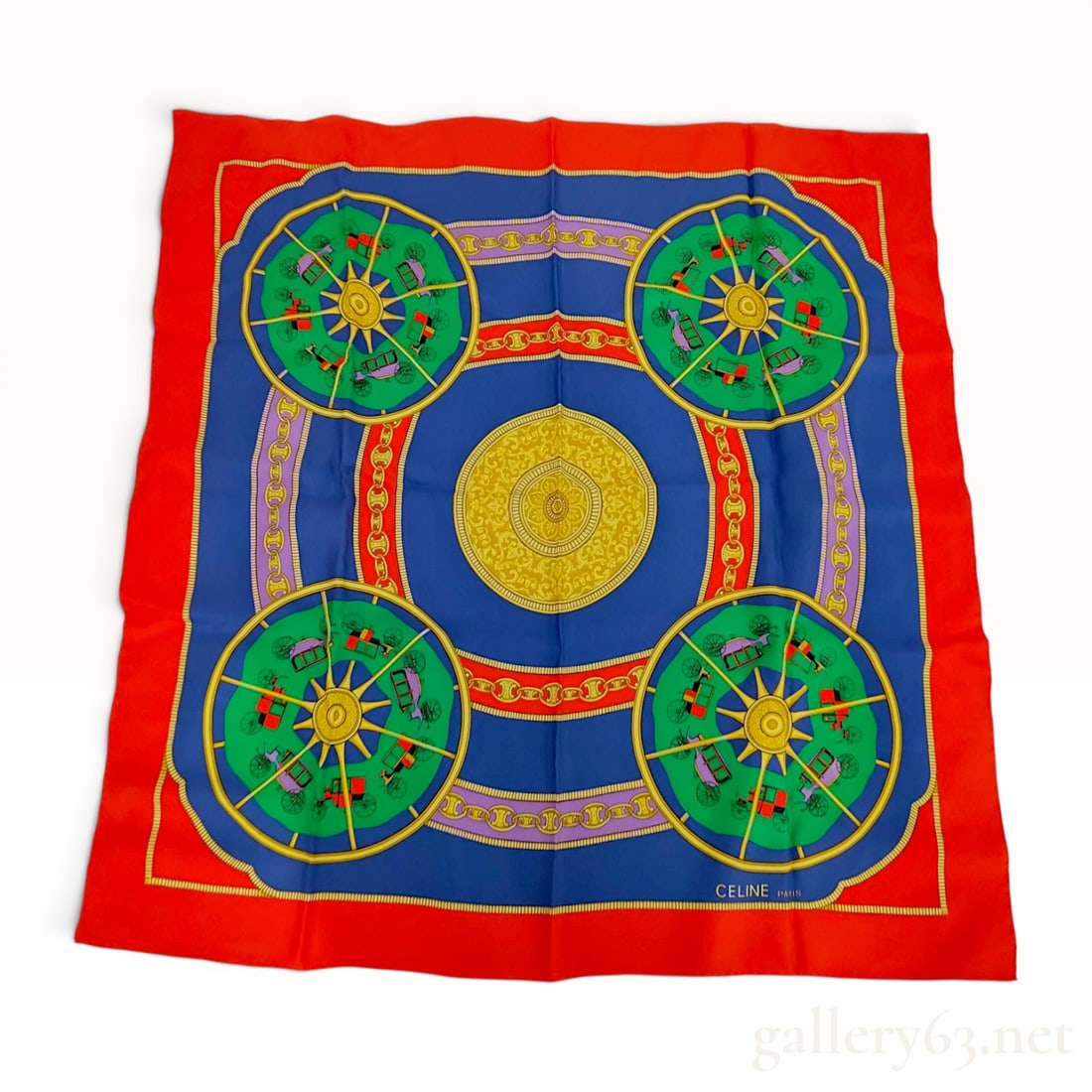 Celine Equestrian Carriage Motif Silk Scarf: Vintage silk twill scarf by Celine, Paris, featuring a large central sunburst medallion on a blue field. The design incorporates four corner carriage vignettes on green grounds, Blazon chain-link bord