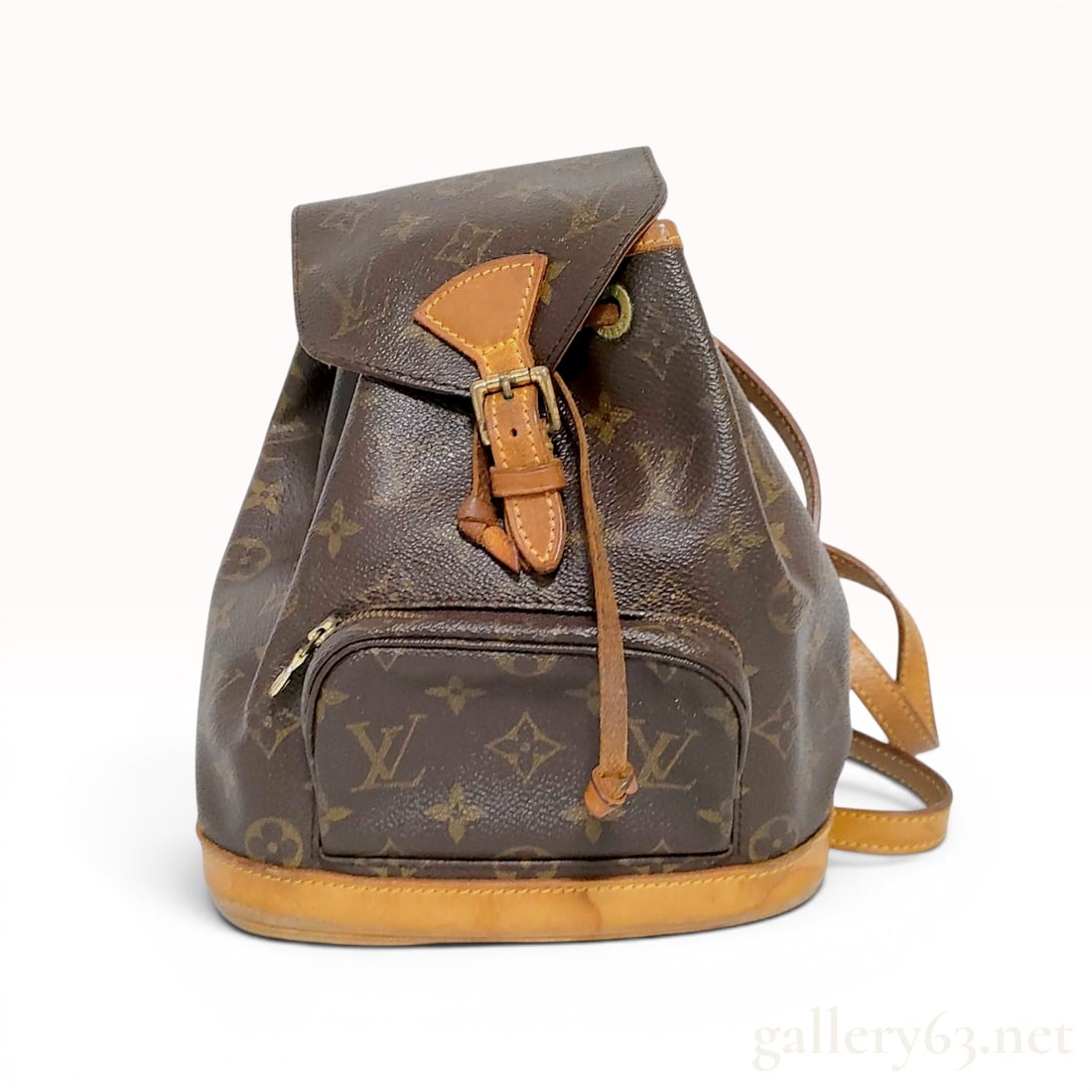 Louis Vuitton Monogram Mini Montsouris Backpack: A small-scale vintage backpack constructed from signature monogram coated canvas with natural vachetta leather accents. The design features a top flap with a brass-tone buckle closure that opens to a 