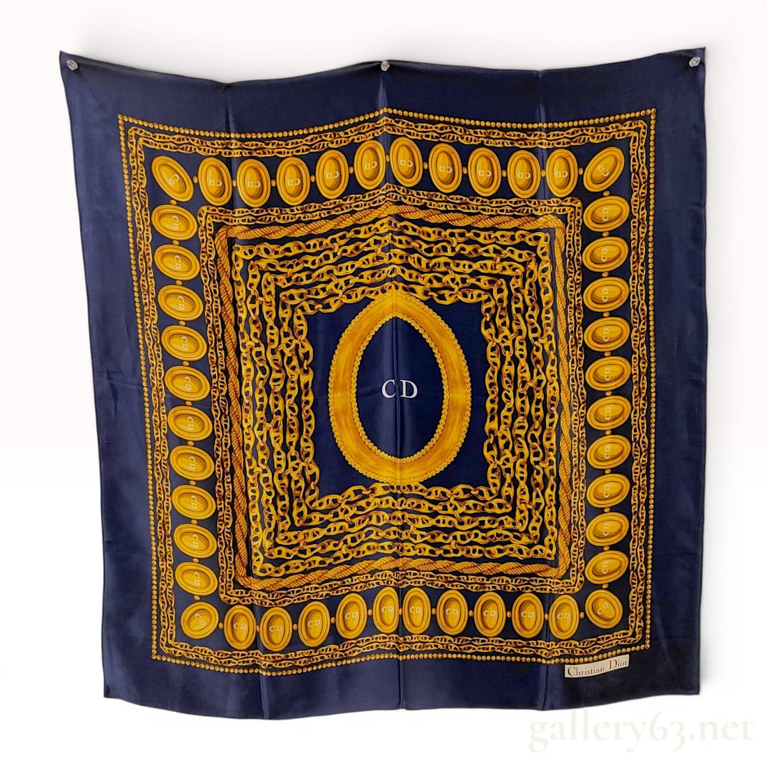 Christian Dior Navy Silk Scarf with Gold Chain and Medallion Motif: Christian Dior square silk scarf featuring an ornate chain and medallion design. The navy blue field is decorated with concentric squares of gold-tone rope and chain motifs surrounding a central CD mo
