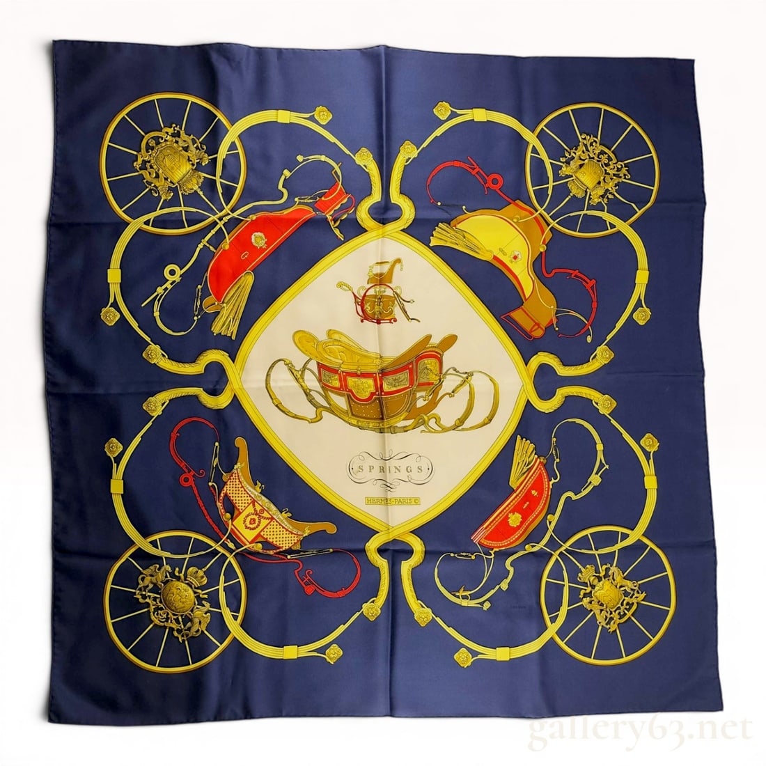 Hermes Springs Silk Twill Scarf by Philippe Ledoux: This authentic Hermes silk twill scarf features the Springs pattern, designed by artist Philippe Ledoux and first issued in 1974. The design depicts various ornate horse-drawn carriages and detailed c
