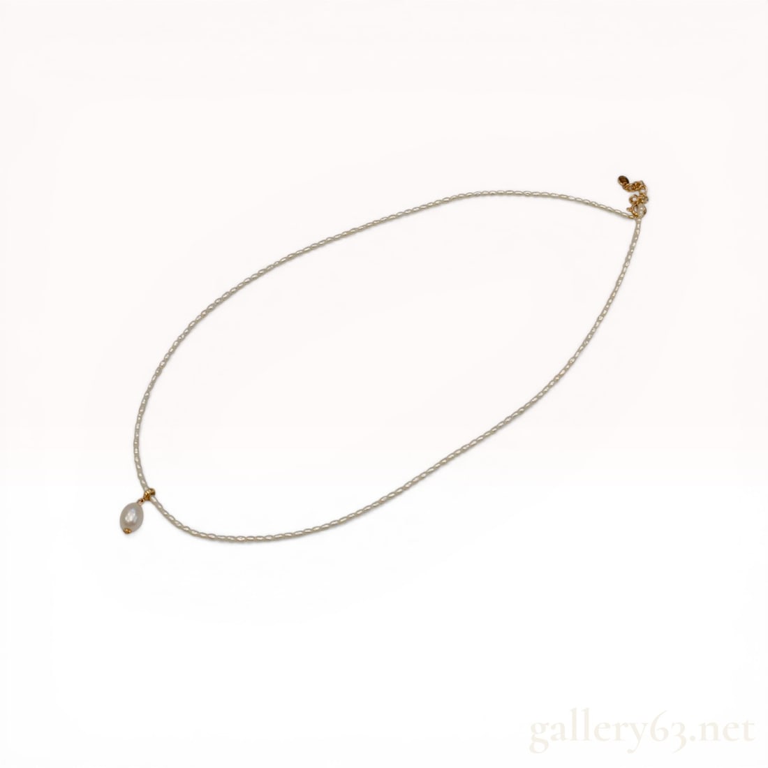 Mikimoto 18K Yellow Gold and Akoya Seed Pearl Necklace with Drop Pendant: Mikimoto cultured pearl strand necklace featuring a single drop-shaped pearl pendant. Constructed with a single strand of white Akoya seed pearls and 18 karat yellow gold hardware including a spring-r