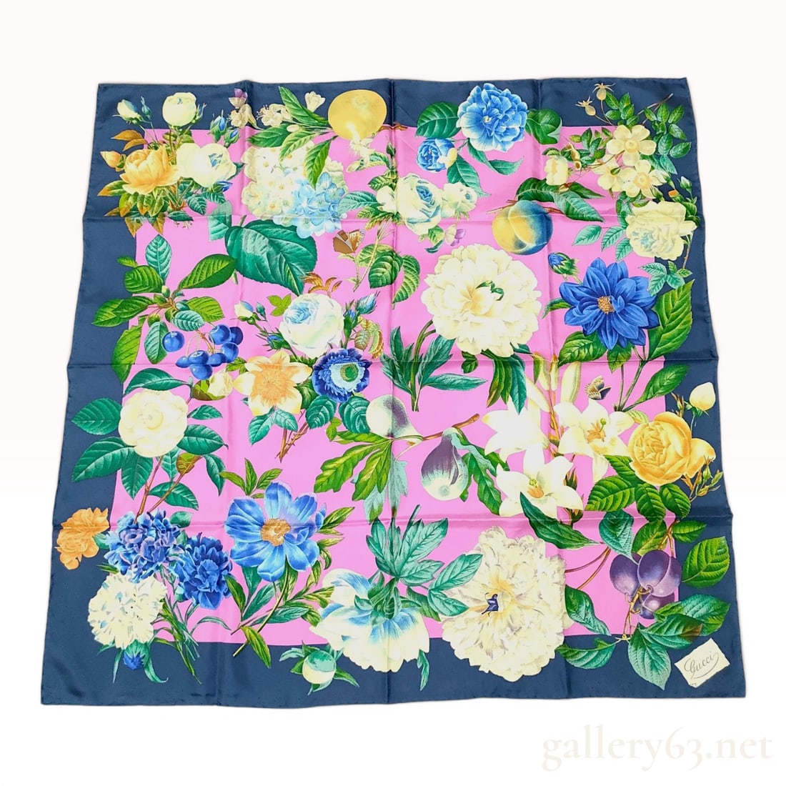 Gucci Flora Pink and Navy Silk Twill Scarf: This square silk scarf features the iconic Flora botanical print, originally designed by Vittorio Accornero for Gucci in 1966. The dense, multi-colored design includes a variety of flora such as lilie