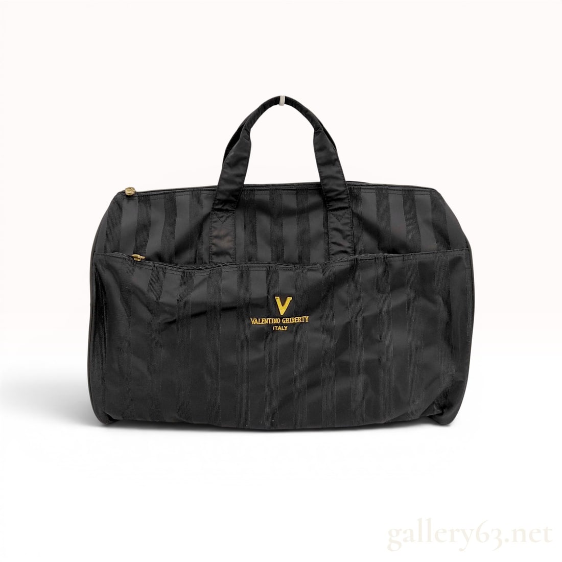 Valentino Ghiberty Italy Black Striped Travel Weekender Bag: Valentino Ghiberty travel weekender bag in black synthetic fabric with a tonal vertical stripe pattern. The bag features dual top webbing carry handles with fabric wraps, a large exterior zippered poc