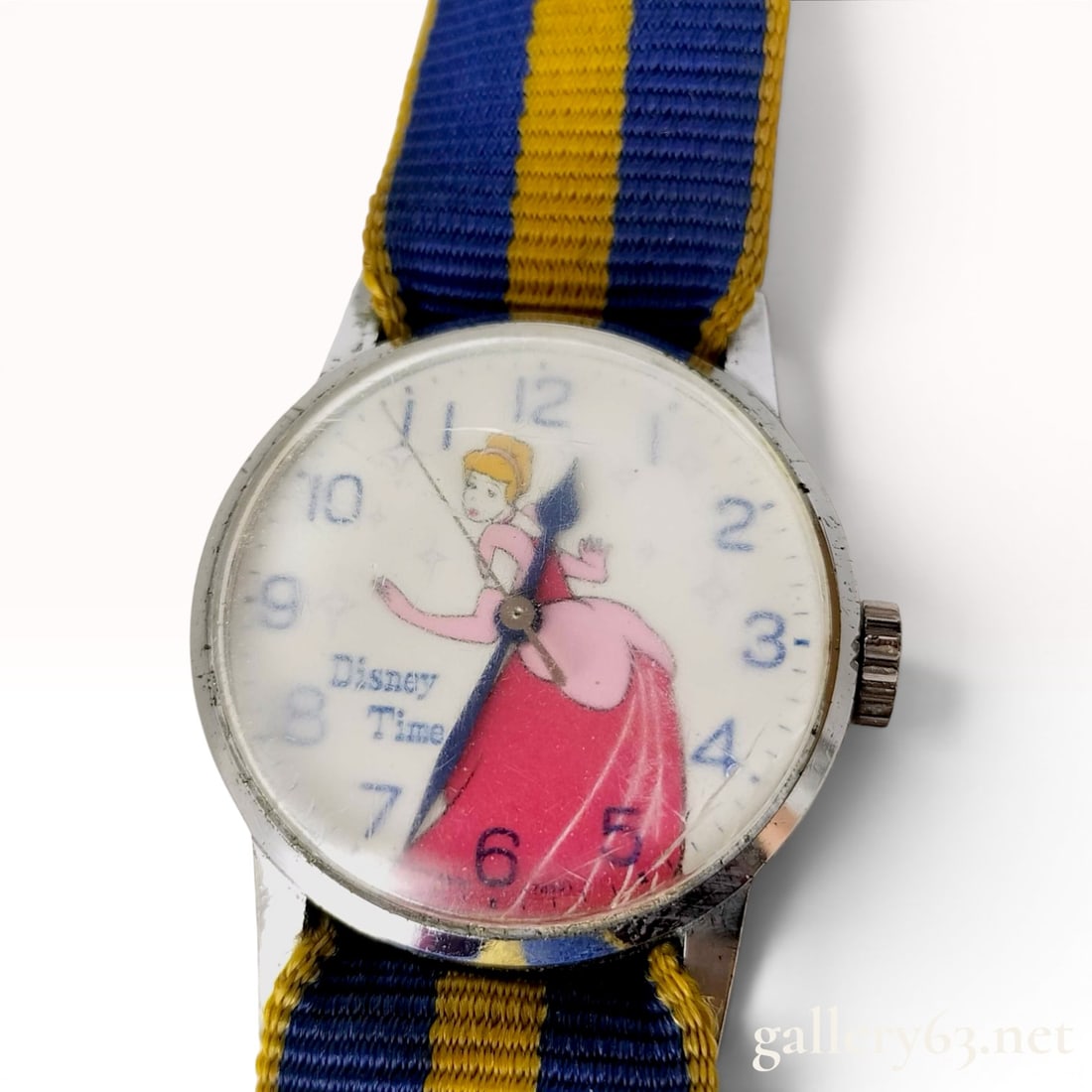Vintage Disney Time Cinderella Character Wristwatch: A vintage character wristwatch featuring the Disney Time branding and an illustration of Walt Disney's Cinderella in her pink ballgown. The white dial is decorated with blue Arabic numeral hour marker