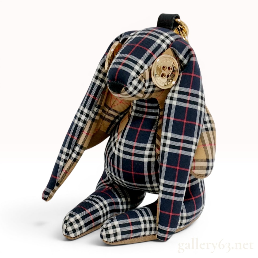 Burberry Multi-Check Fabric Bunny Bag Charm with Original Box: This Burberry bag charm is designed as a stuffed bunny with moveable limbs, constructed from multiple variations of the Burberry check pattern. The head, body, and outer ears feature a navy-colored ba