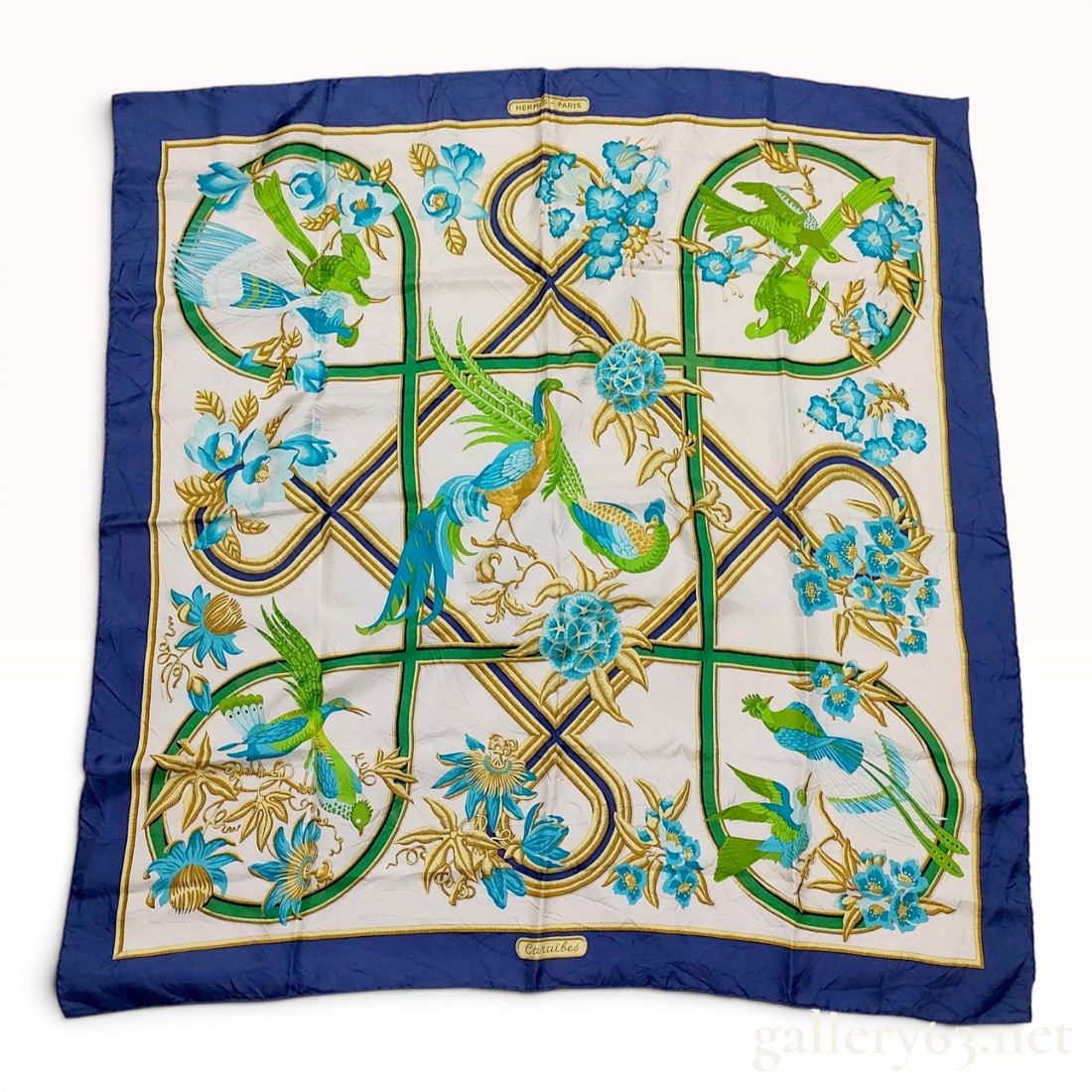 Hermes Caraibes Silk Scarf: A vintage Hermes Paris silk twill scarf in the Caraibes (Caribbean) pattern designed by Christiane Vauzelles. The design features a central arrangement of tropical birds and exotic flora, including hu