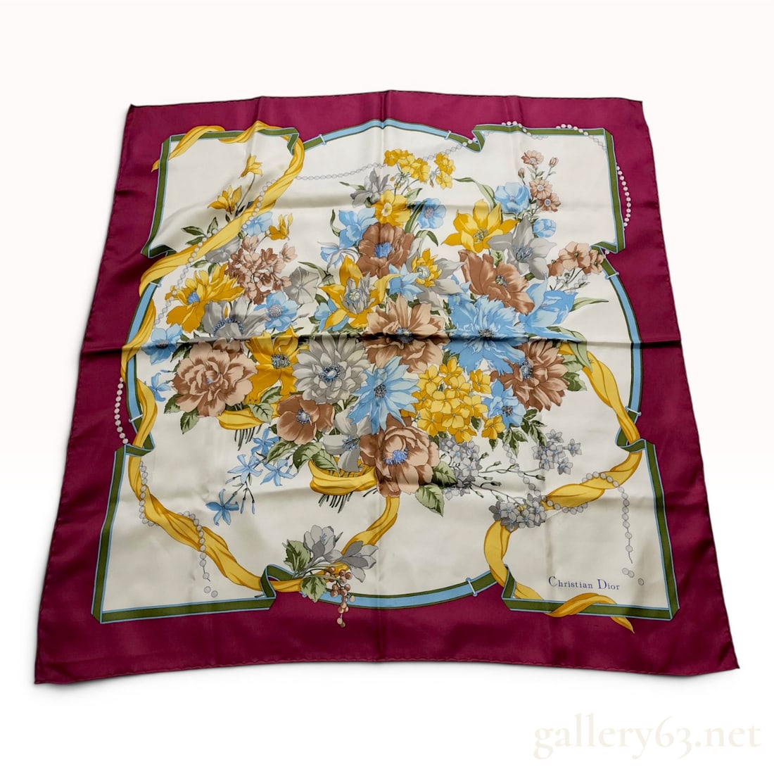 Christian Dior Floral and Ribbon Motif Silk Scarf: Christian Dior silk scarf featuring a large floral bouquet with ribbon and pearl accents, late 20th century. Printed silk twill with an off-white field and a broad burgundy border. Signed Christian Di