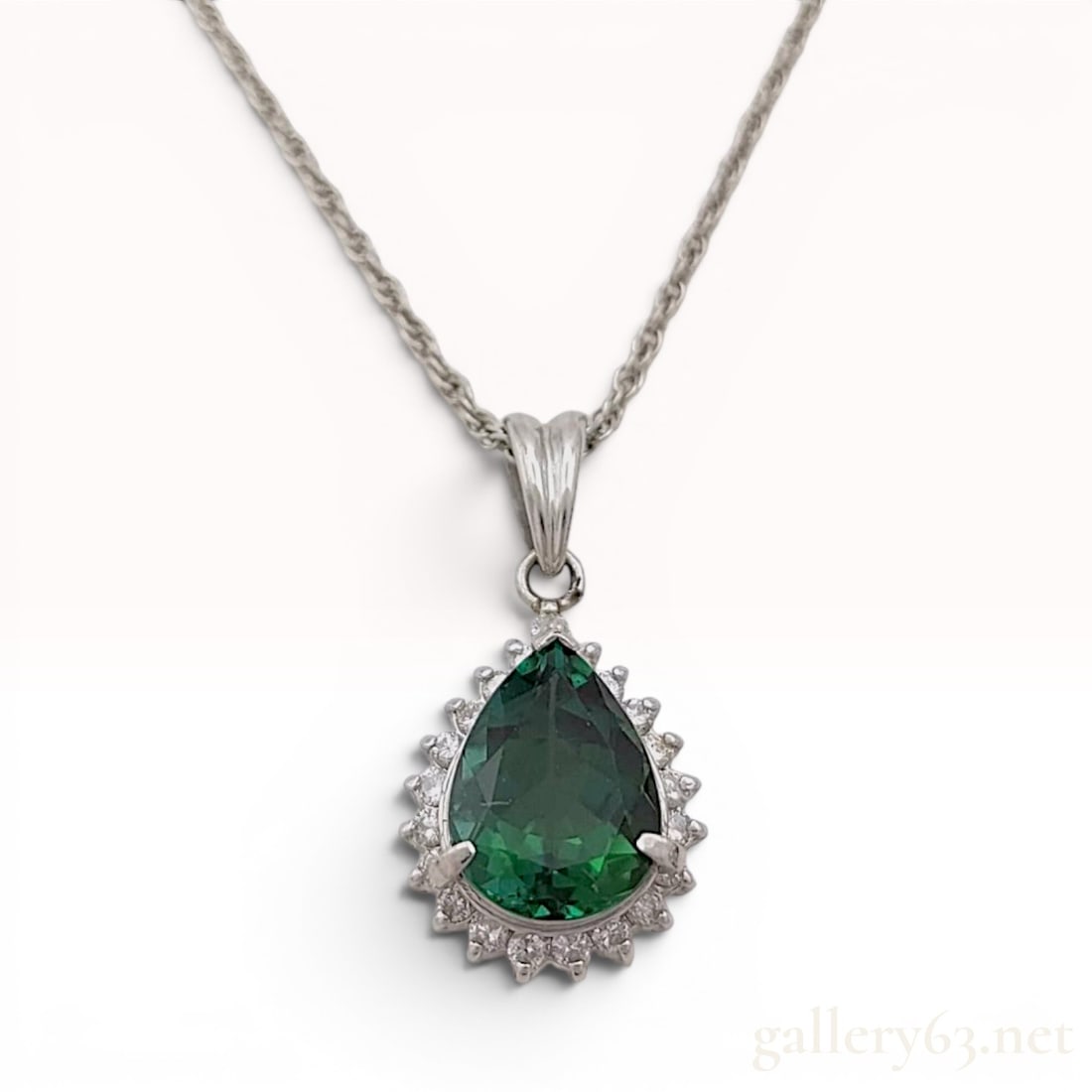 Platinum Natural 2.46ct Lagoon Tourmaline and Diamond Halo Pendant Necklace: This platinum necklace features a pendant set with a pear-shape mixed-cut natural deep blue-green tourmaline surrounded by a halo of natural diamonds. The primary tourmaline weighs approximately 2.46 