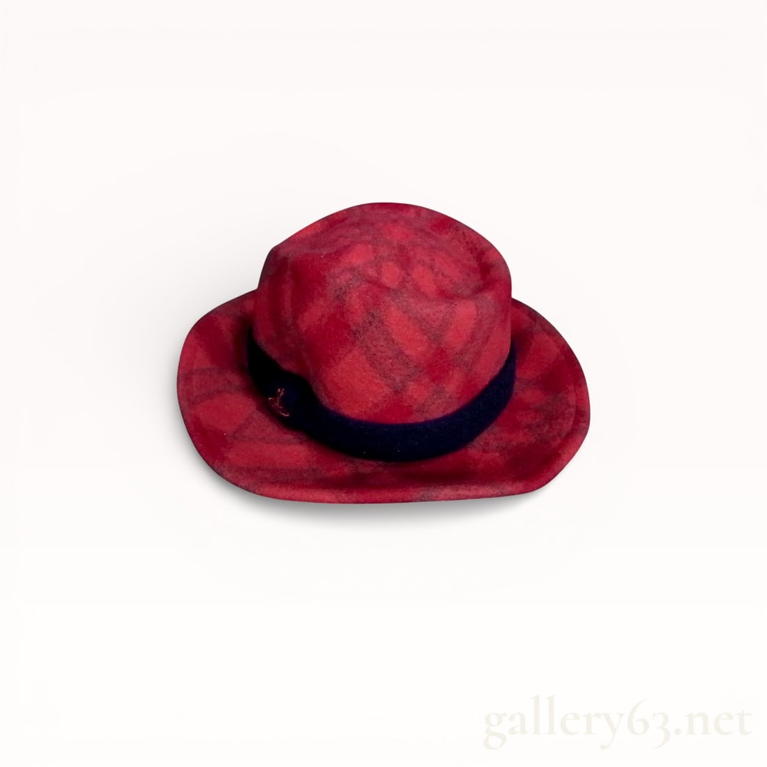 Vivienne Westwood Red Plaid Wool Fedora Hat: Vivienne Westwood fedora hat, late 20th to early 21st century. The hat is constructed from 100 percent brushed wool in a red and charcoal grey plaid pattern with a navy blue felt band and a red metal 