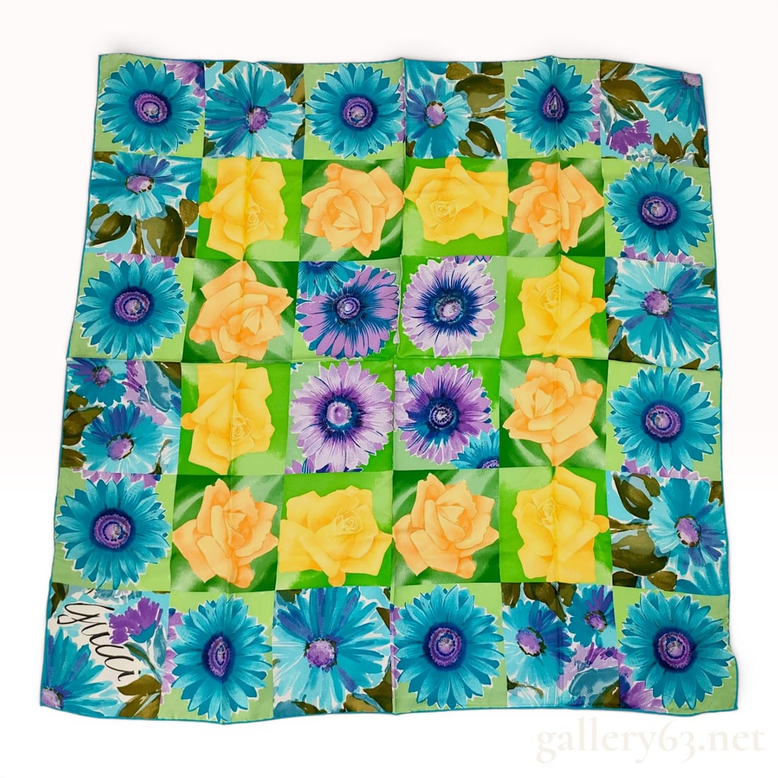Gucci Silk Floral Grid Pattern Square Scarf: A square designer scarf by Gucci featuring a vibrant floral grid or checkerboard pattern. The design consists of alternating squares depicting large-scale gerbera daisies in shades of teal, blue, and 