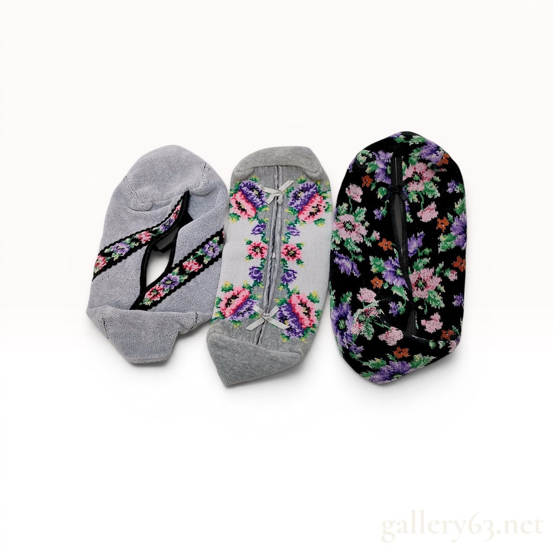 A Trio of Feiler Floral Chenille Tissue Box Covers: Feiler chenille tissue box covers, late 20th century. Three plush cotton fabric sleeves in black, white, and grey floral motifs featuring ribbon tie closures and one interior black lining. Each piece 