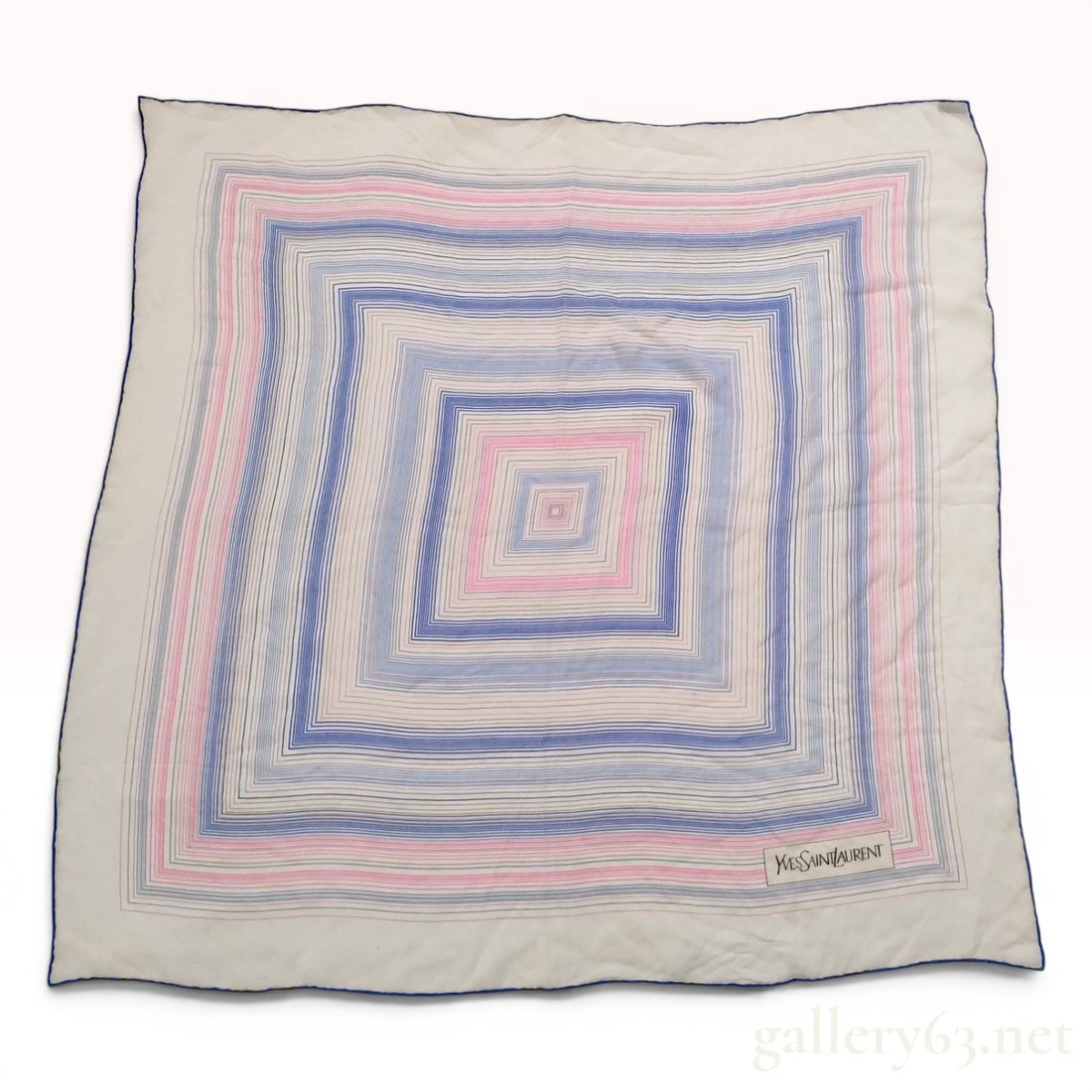 Yves Saint Laurent Geometric Pattern Silk Scarf: A vintage silk scarf manufactured by Yves Saint Laurent. The item features a concentric geometric design of nested square lines in blue, pink, and gray tones against an off-white ground. The borders a