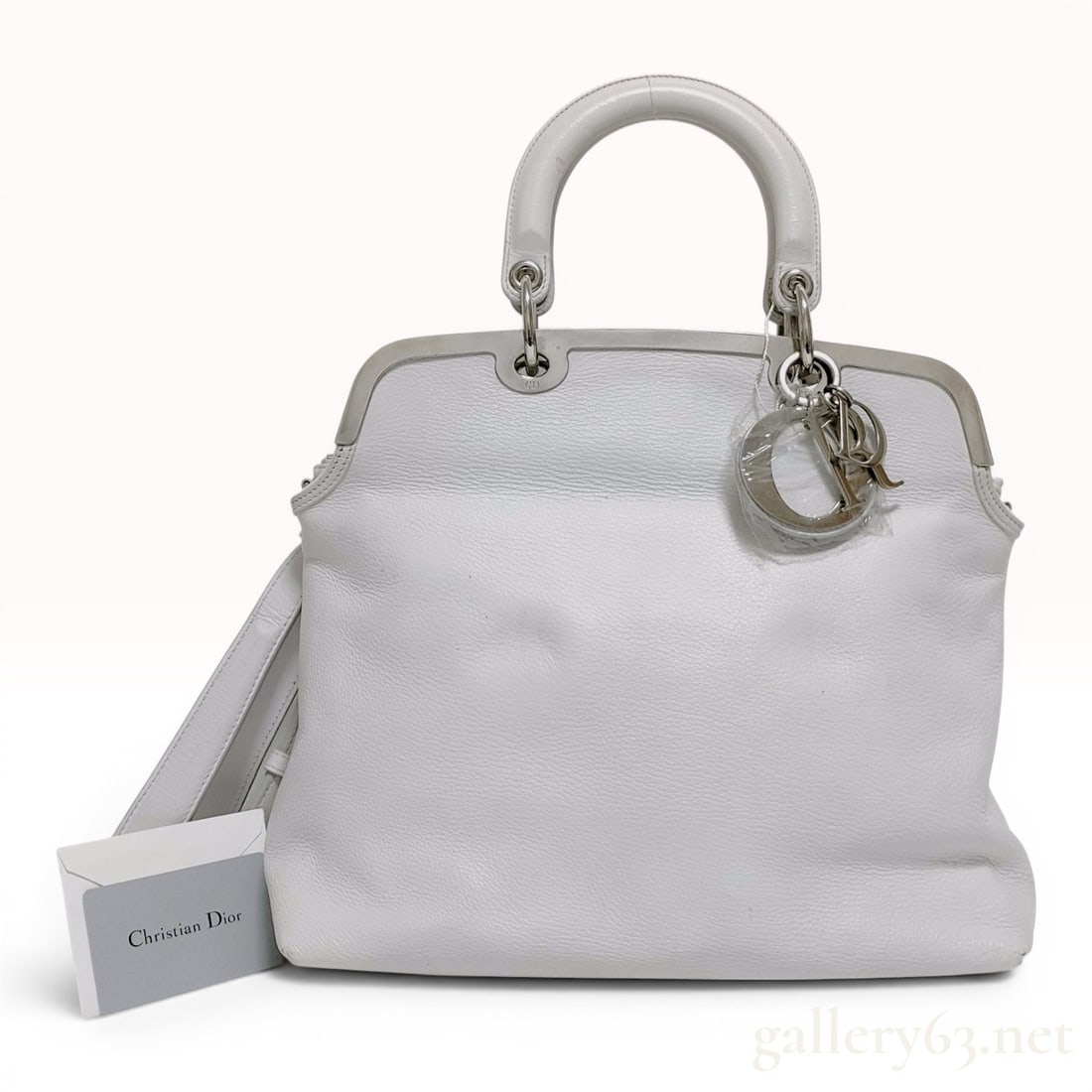 Christian Dior White Grained Leather Granville Frame Bag: A Christian Dior Granville frame bag, also referred to as a doctor bag silhouette, crafted from supple white grained pebbled leather. The bag features a structured silver-tone metal frame top with dou