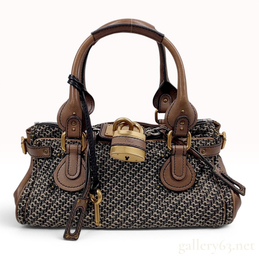 Chloe Paddington Houndstooth Fabric and Brown Leather Satchel: This Chloe Paddington satchel is constructed with a black and cream woven houndstooth fabric body and chocolate brown leather trim. A central design element is the signature oversized functional brass