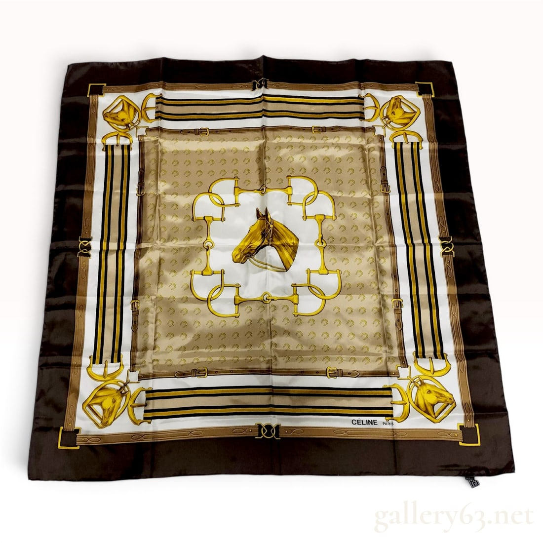 Celine Paris Equestrian Theme Silk Scarf with Horse and Bit Motif: A square silk scarf by Celine Paris featuring a classic equestrian motif. The central design depicts a profile of a horse head within a border of four gold-tone snaffle bits, set against a tan field w