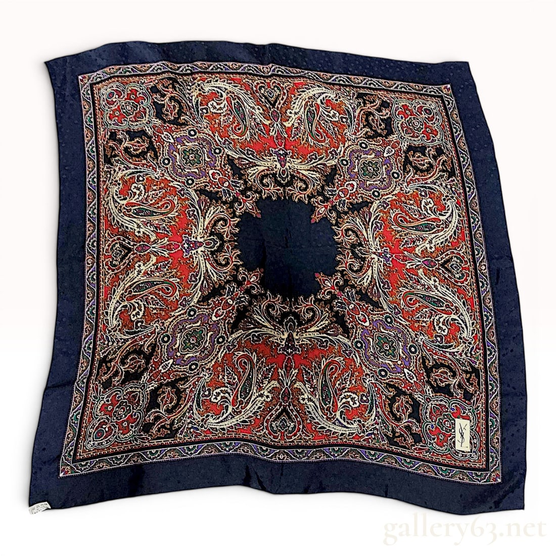 Yves Saint Laurent Silk Foulard Paisley Scarf with Jacquard Polka Dot Pattern: A vintage Yves Saint Laurent square silk foulard featuring a central field and wide outer border in navy blue. The navy blue sections are embellished with a subtle tone-on-tone woven jacquard polka do