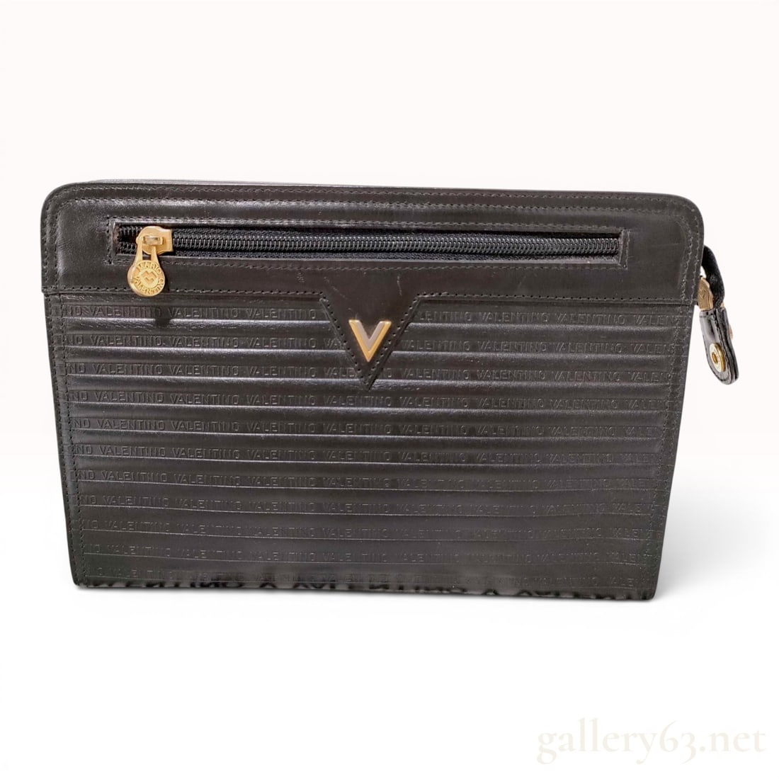 Mario Valentino Vintage Black Embossed Leather Portfolio Clutch Bag: This vintage portfolio clutch bag is produced by Mario Valentino, as indicated by the interior metal plaque and zipper pulls. It is constructed from black leather featuring an all-over embossed patter