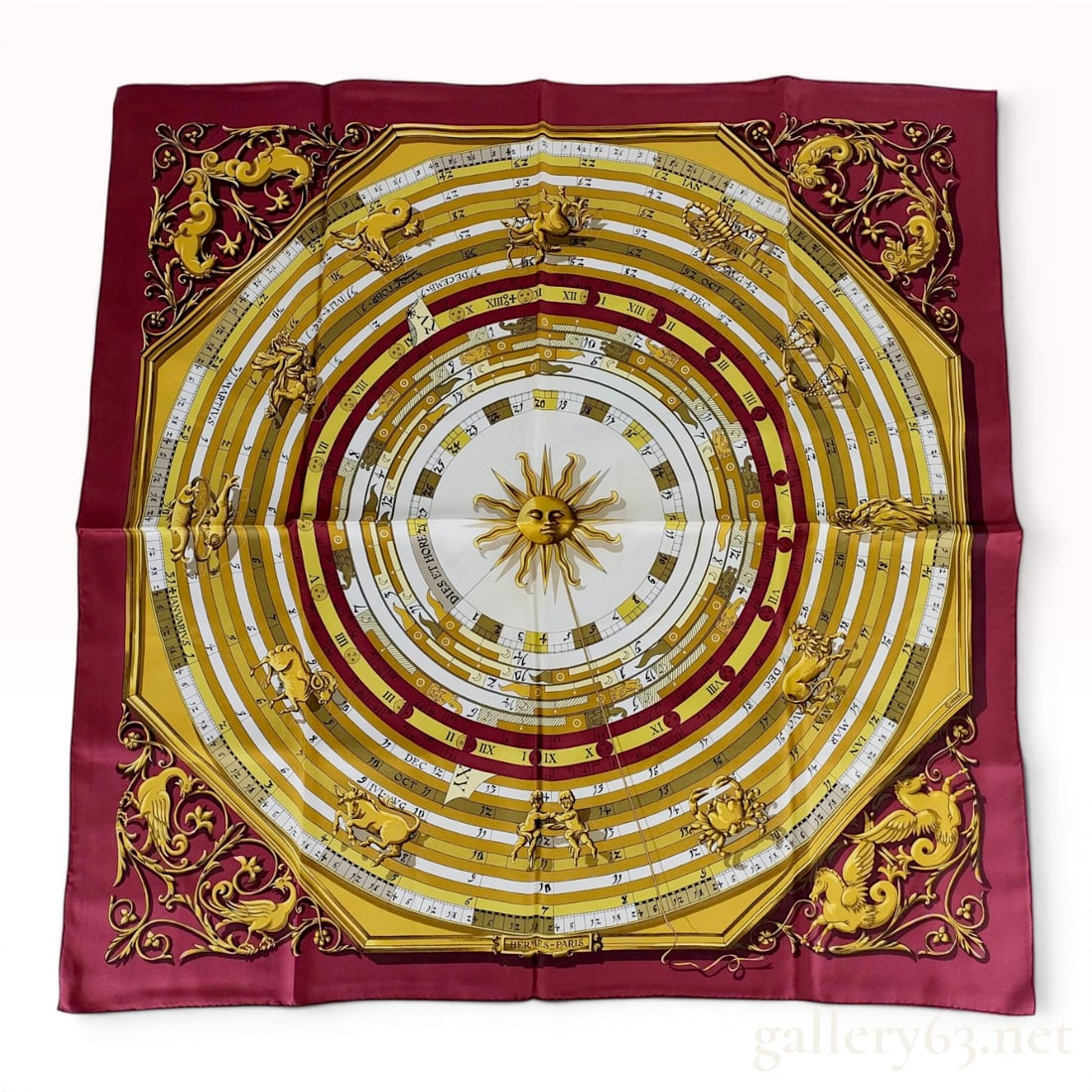 Hermes Silk Carre Scarf Dies et Hore by Francoise Faconnet: This Hermes silk scarf, titled Dies et Hore (Days and Hours), features a design by Francoise Faconnet centered on an astrological and calendrical theme. The central image is a golden anthropomorphic s